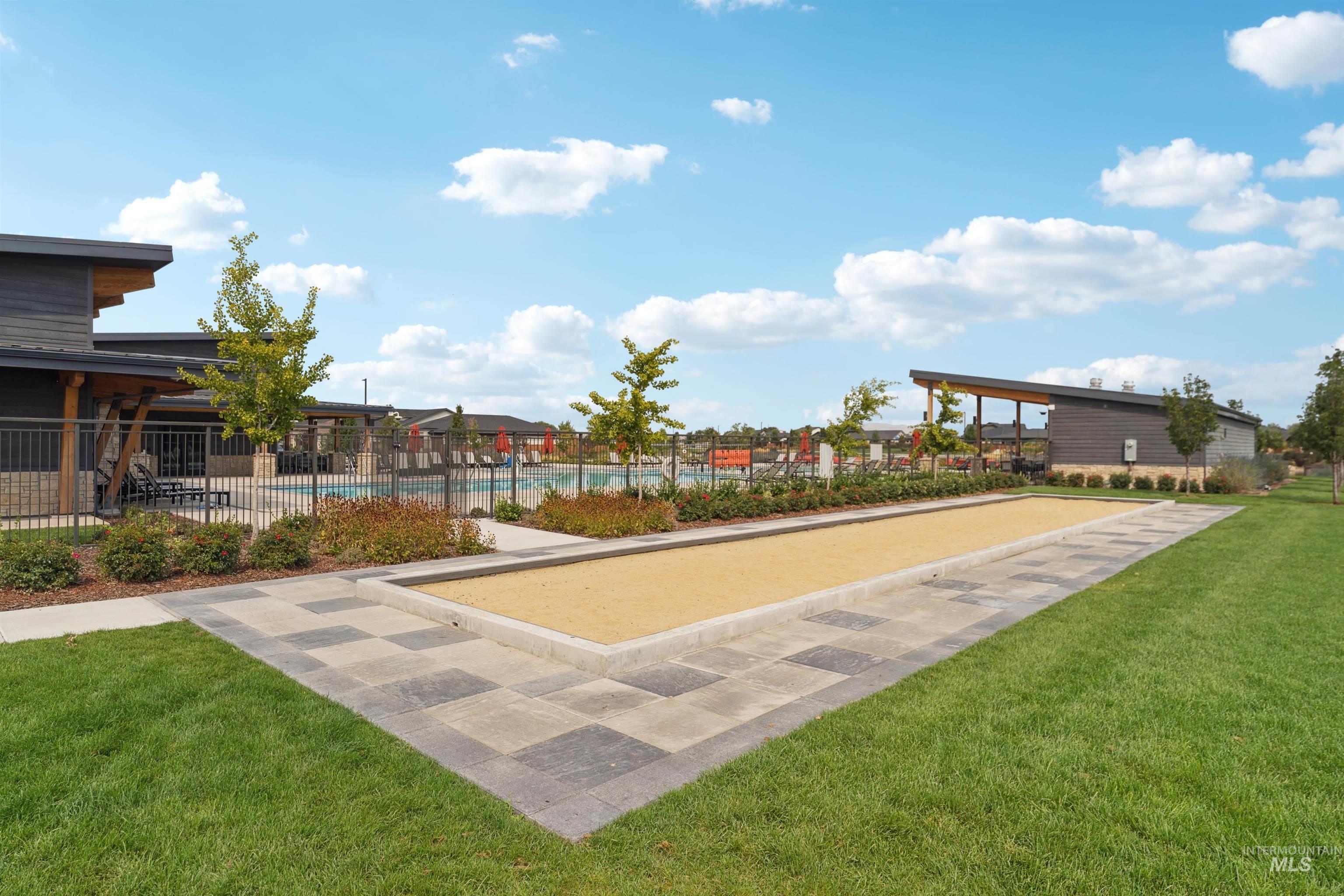Surrounding community with a game area and a swimming pool