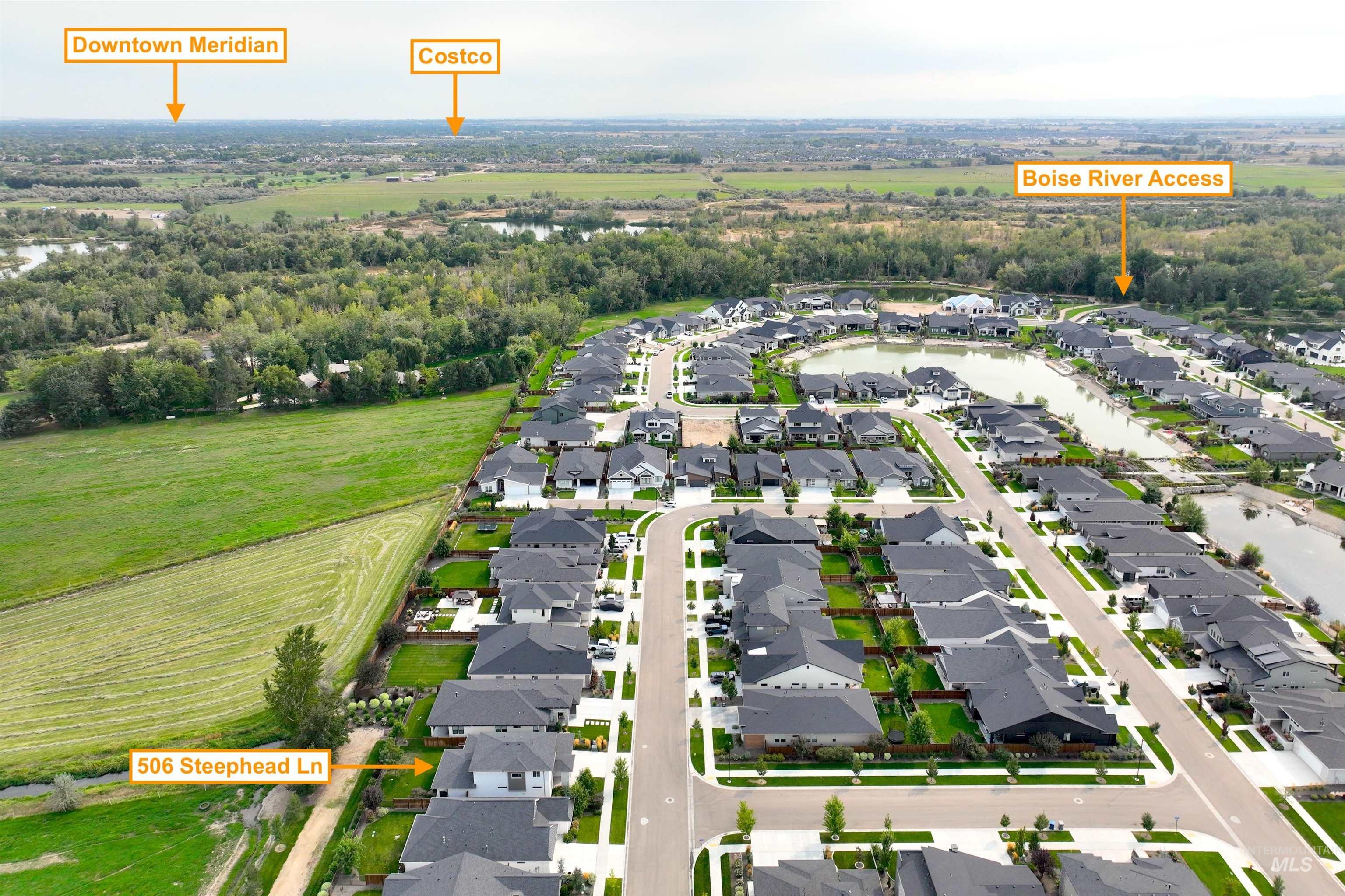 Aerial view of residential area featuring a large body of water