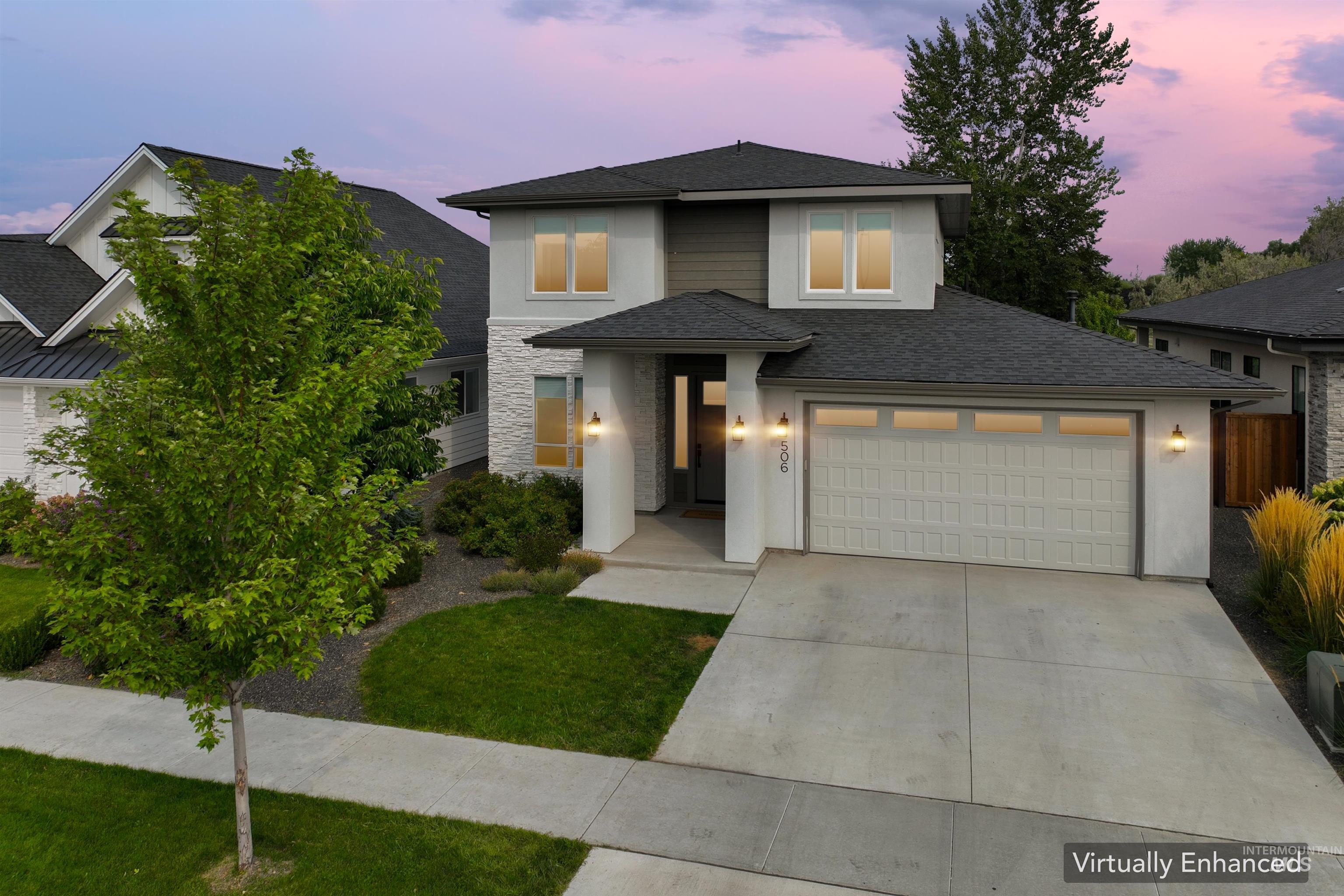 Prairie-style home with a garage, concrete driveway, stone siding, and roof with shingles