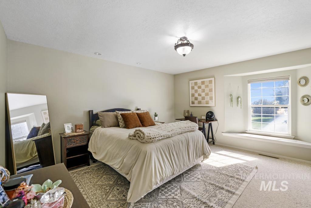 Bedroom with carpet floors and a textured ceiling