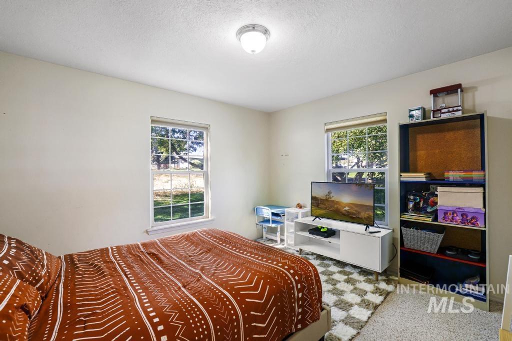 Carpeted bedroom featuring a textured ceiling