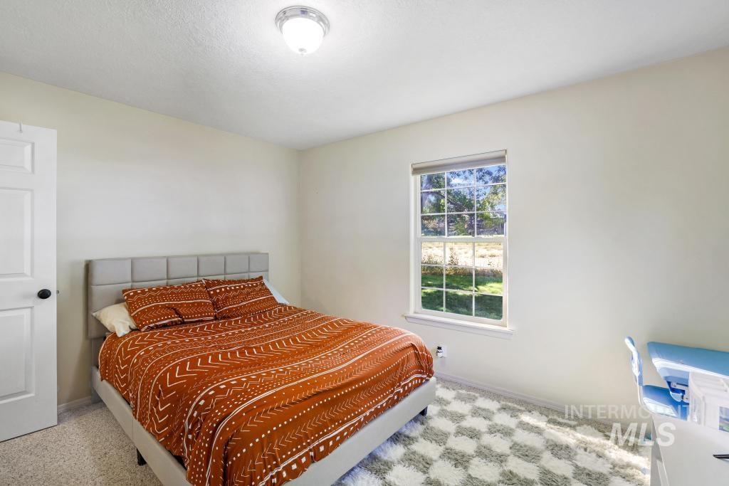 Bedroom featuring baseboards and a textured ceiling