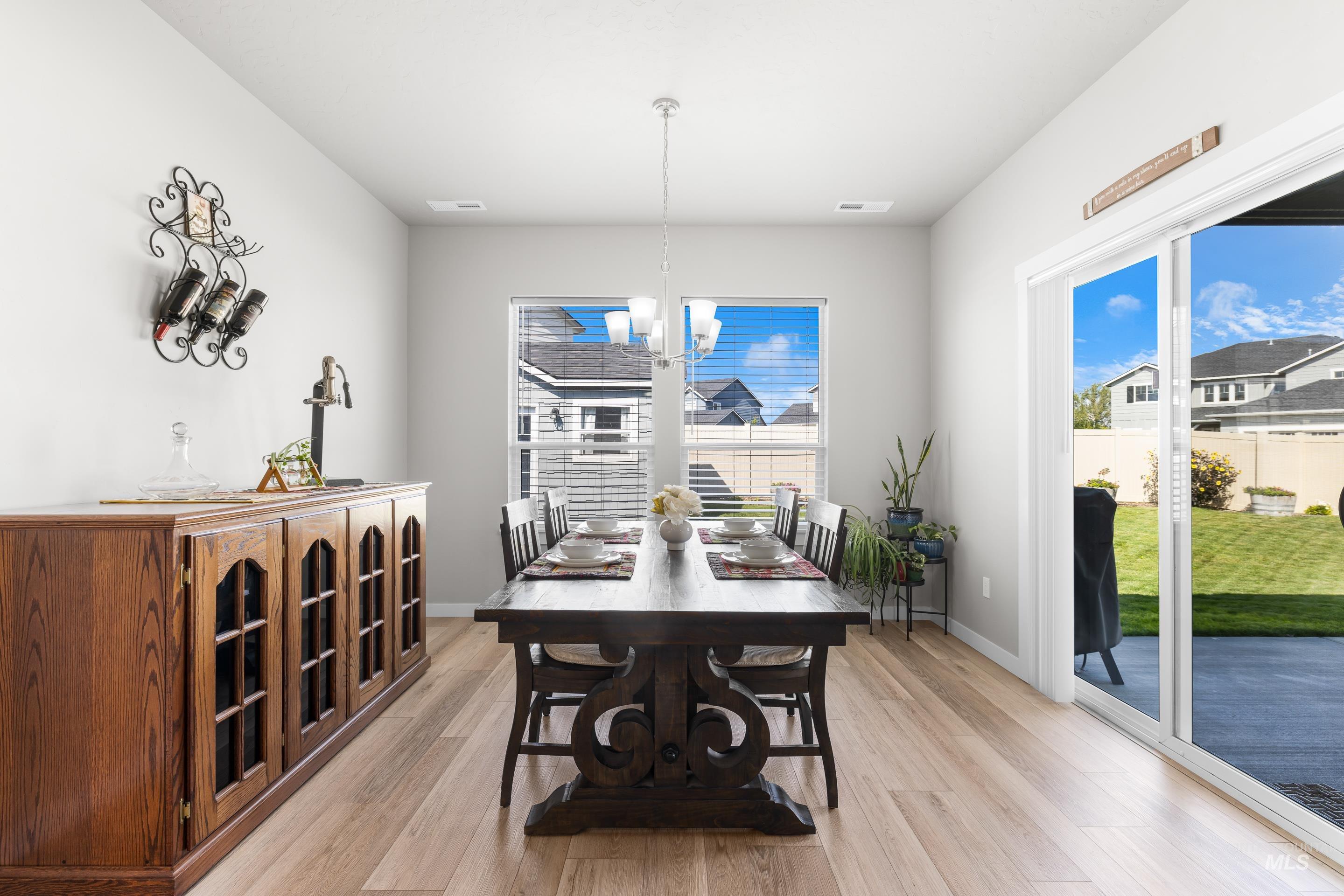 Dining area with a chandelier and light wood-style floors