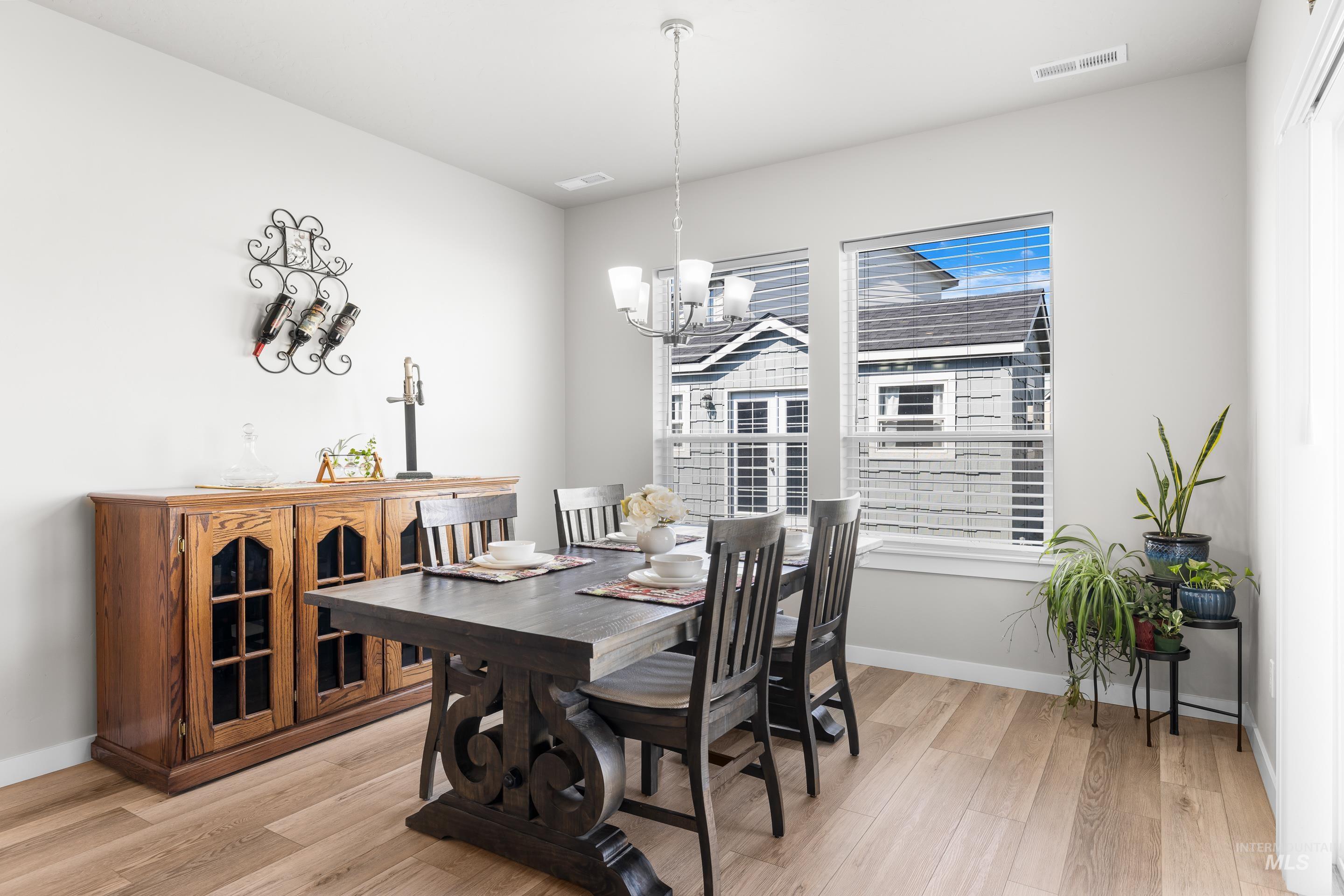 Dining area featuring light wood-style flooring and a chandelier
