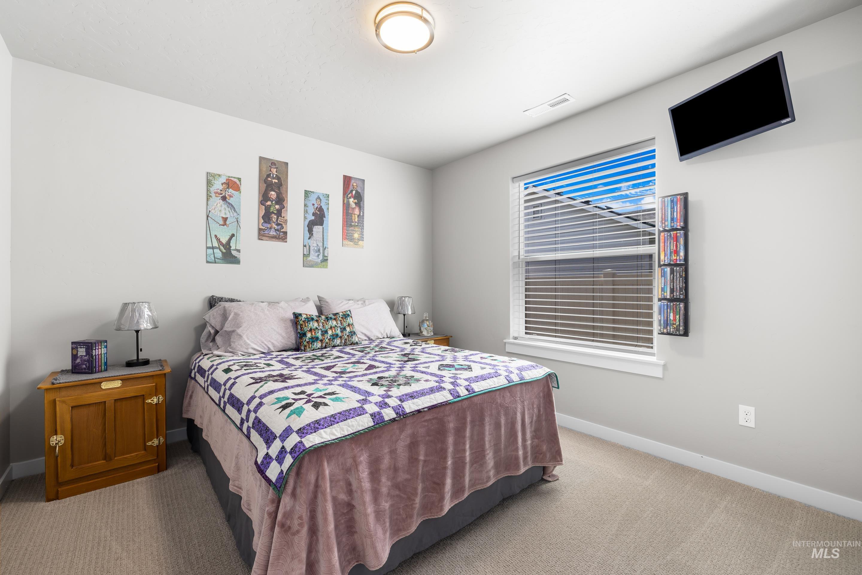 Bedroom with carpet flooring and baseboards