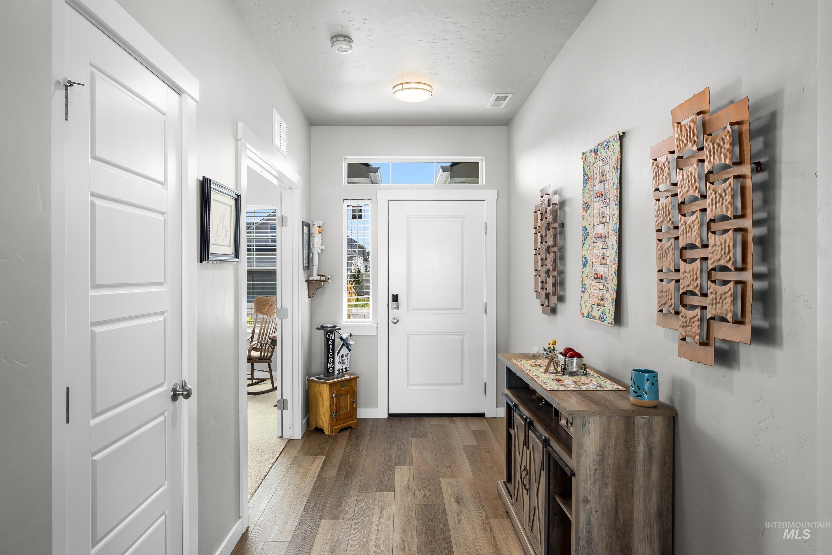 Foyer with wood finished floors and a textured ceiling