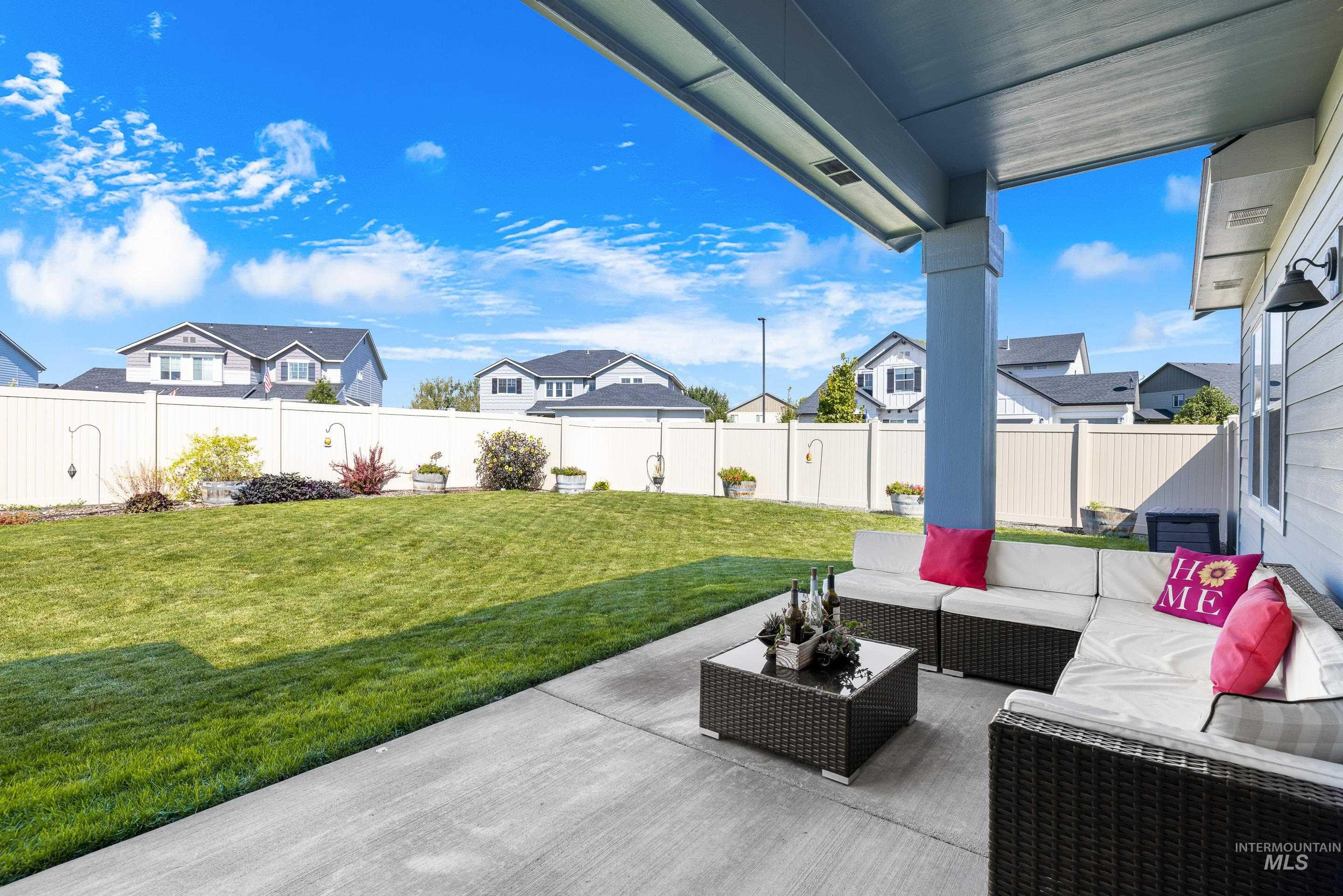 Fenced backyard with a residential view and a patio area