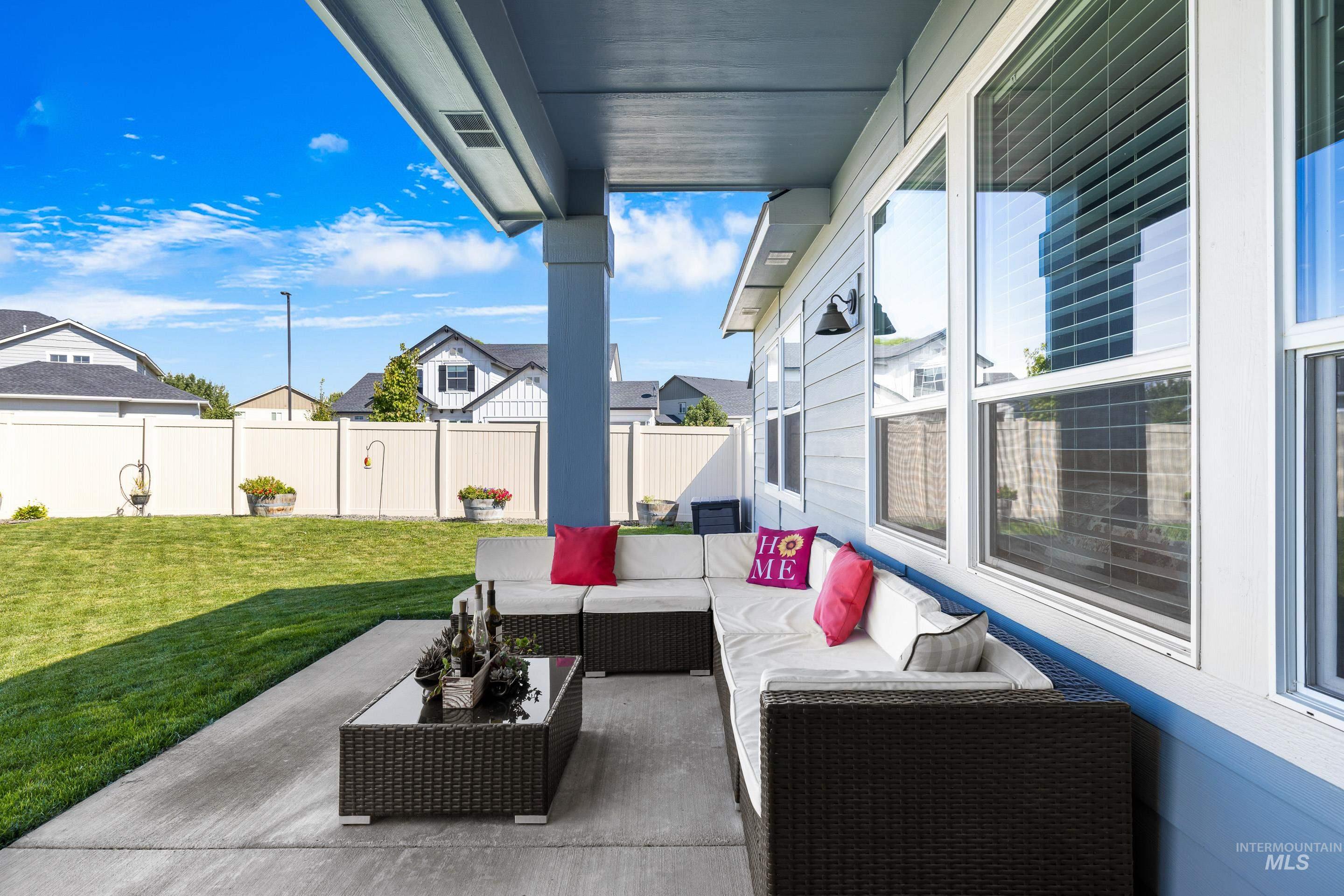Fenced backyard featuring a patio and an outdoor hangout area