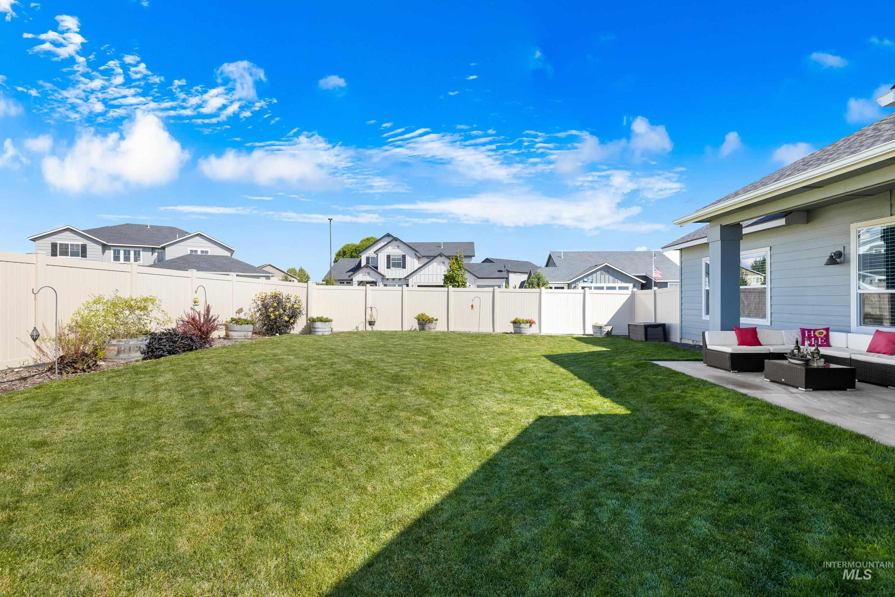 Fenced backyard with outdoor lounge area, a residential view, and a patio