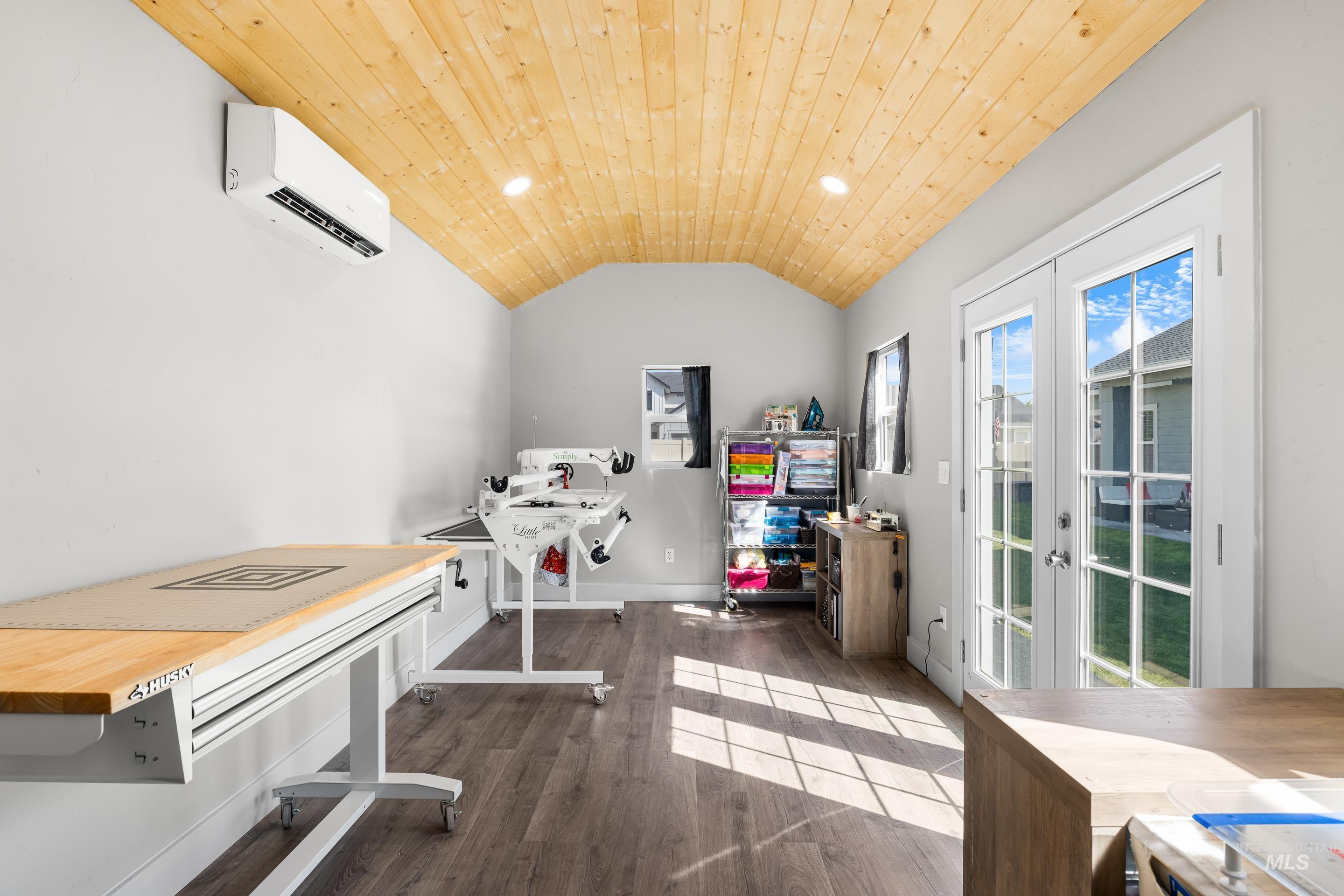 Washroom with french doors, dark wood-style flooring, recessed lighting, wooden ceiling, and a wall unit AC