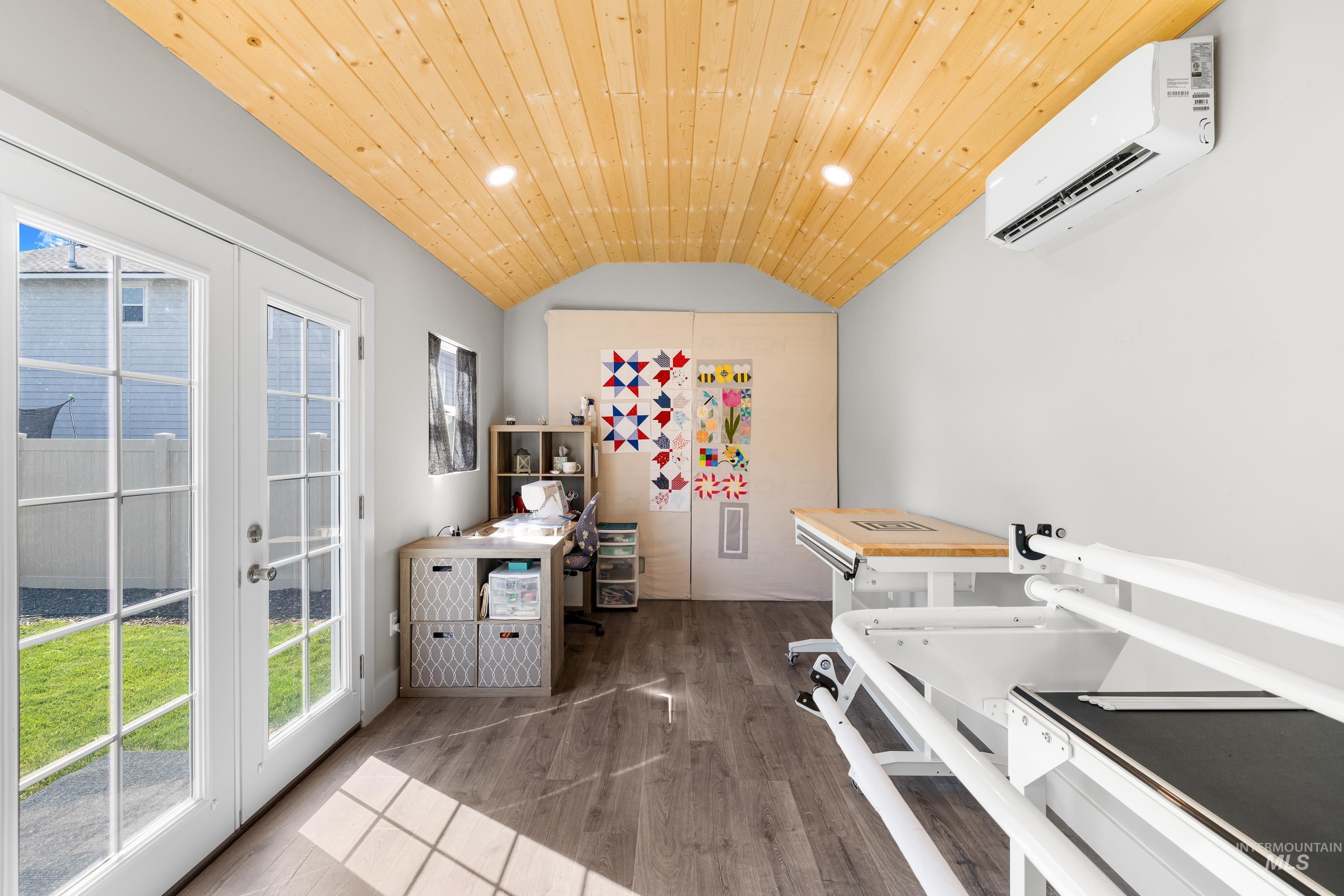 Laundry room with wood finished floors, recessed lighting, a wall mounted AC, french doors, and wooden ceiling
