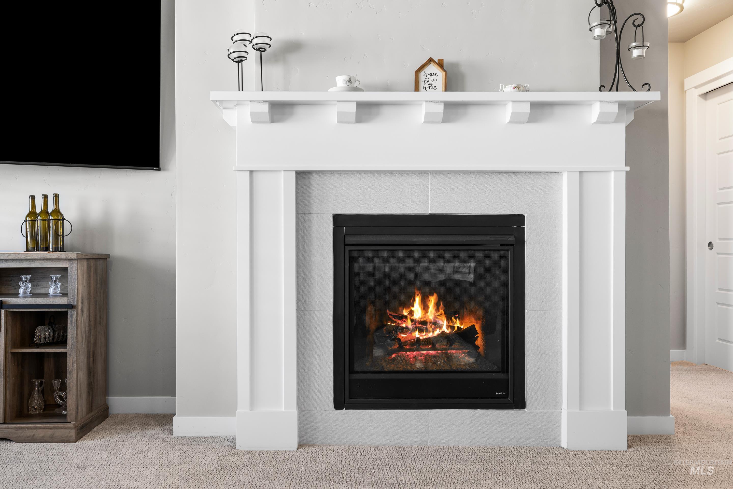 Detailed view of carpet flooring and a tile fireplace