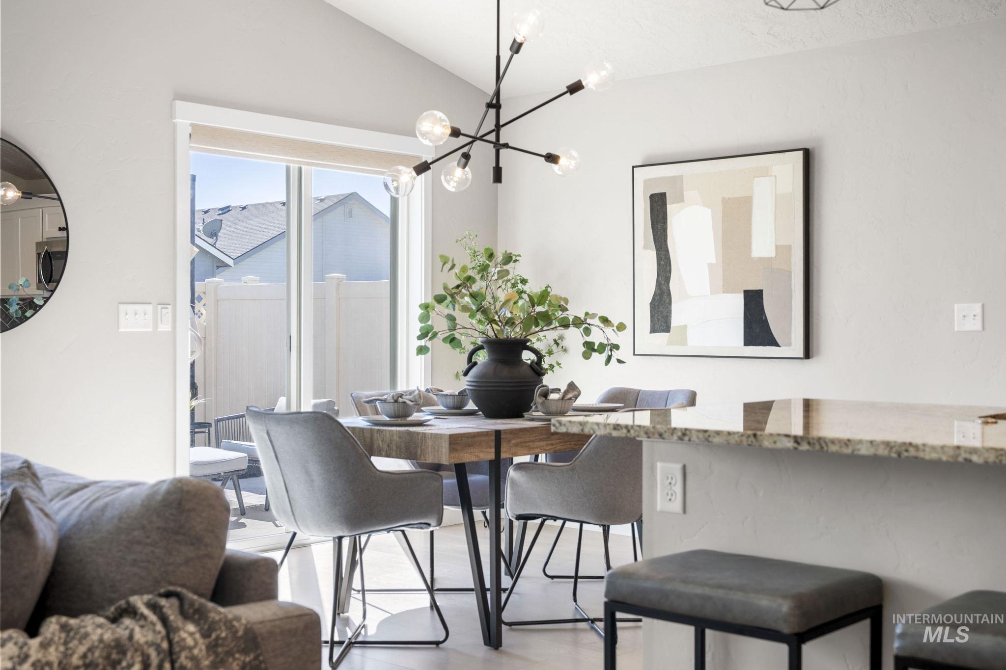 Dining space featuring lofted ceiling and a chandelier