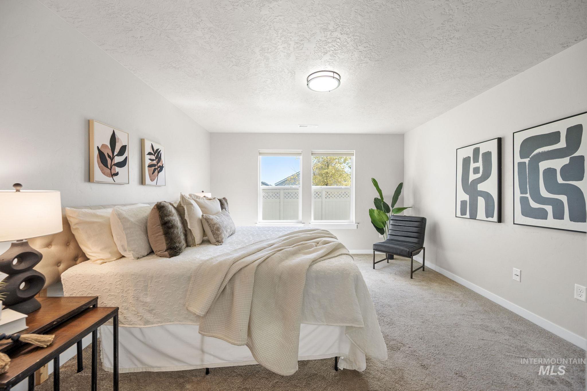 Bedroom featuring a textured ceiling and carpet flooring