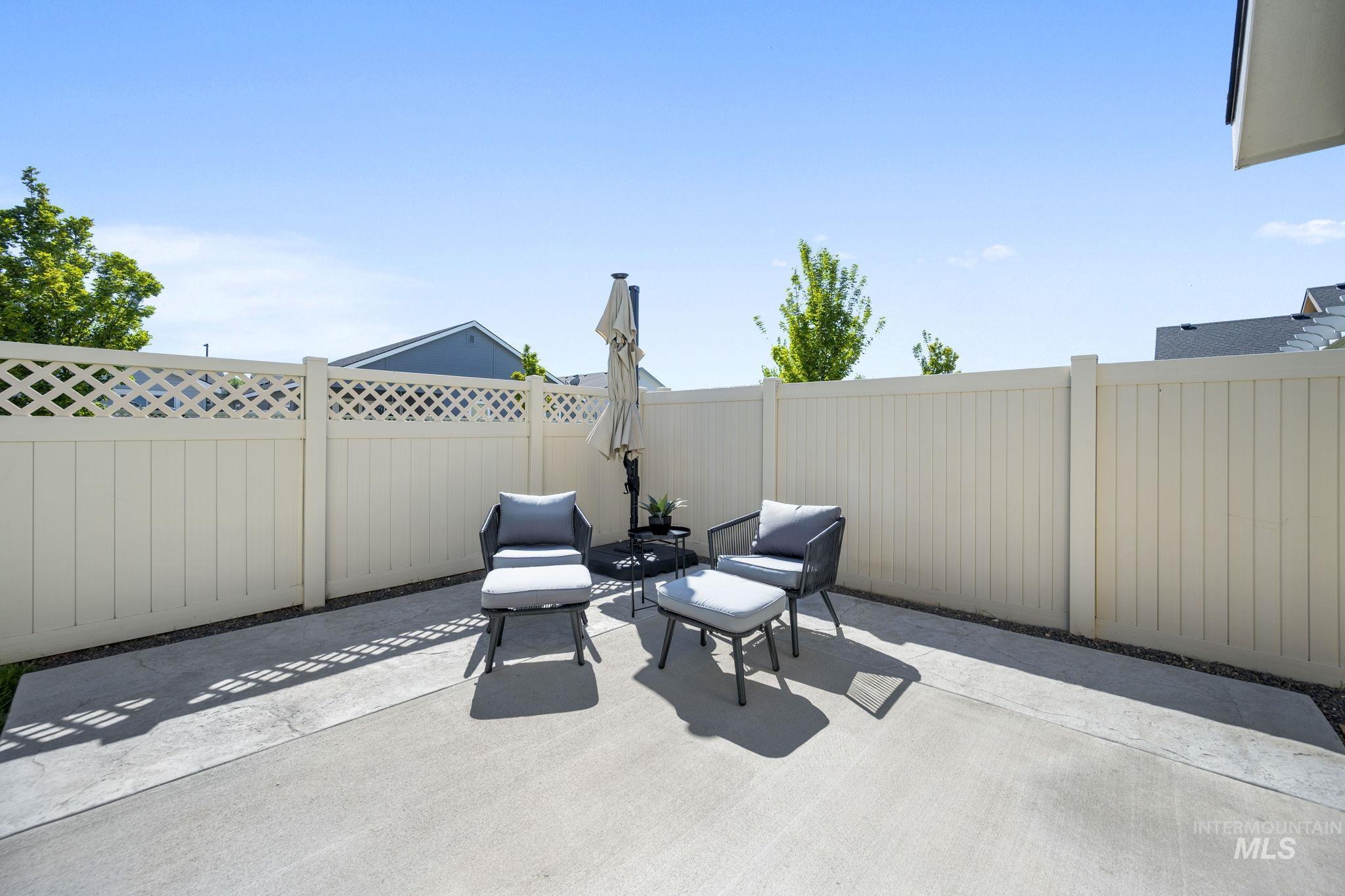 Fenced backyard with a patio