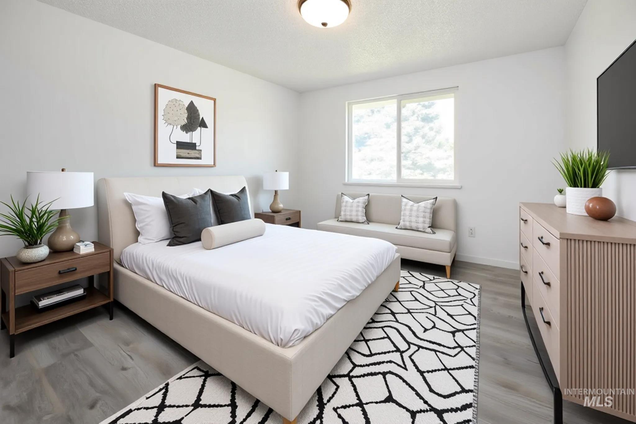 Bedroom featuring light wood-type flooring and a textured ceiling