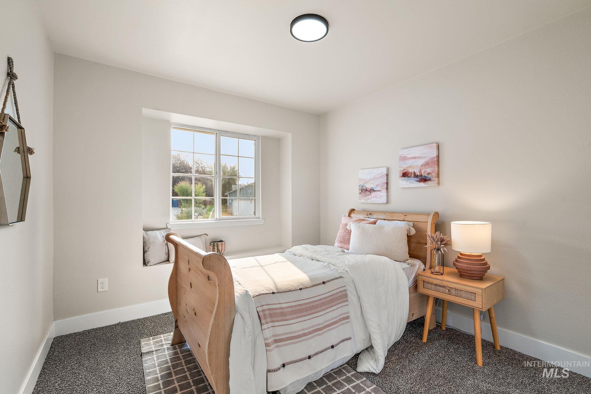 Bedroom featuring baseboards and carpet
