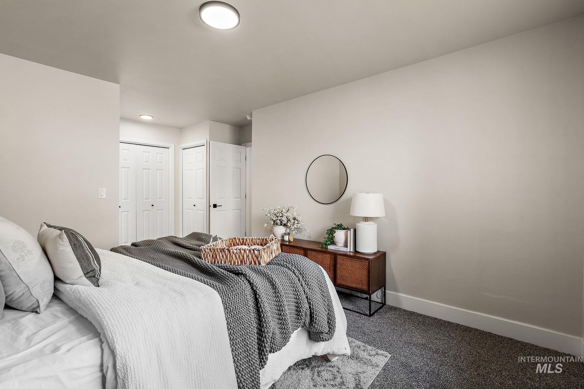 Carpeted bedroom with baseboards and a closet