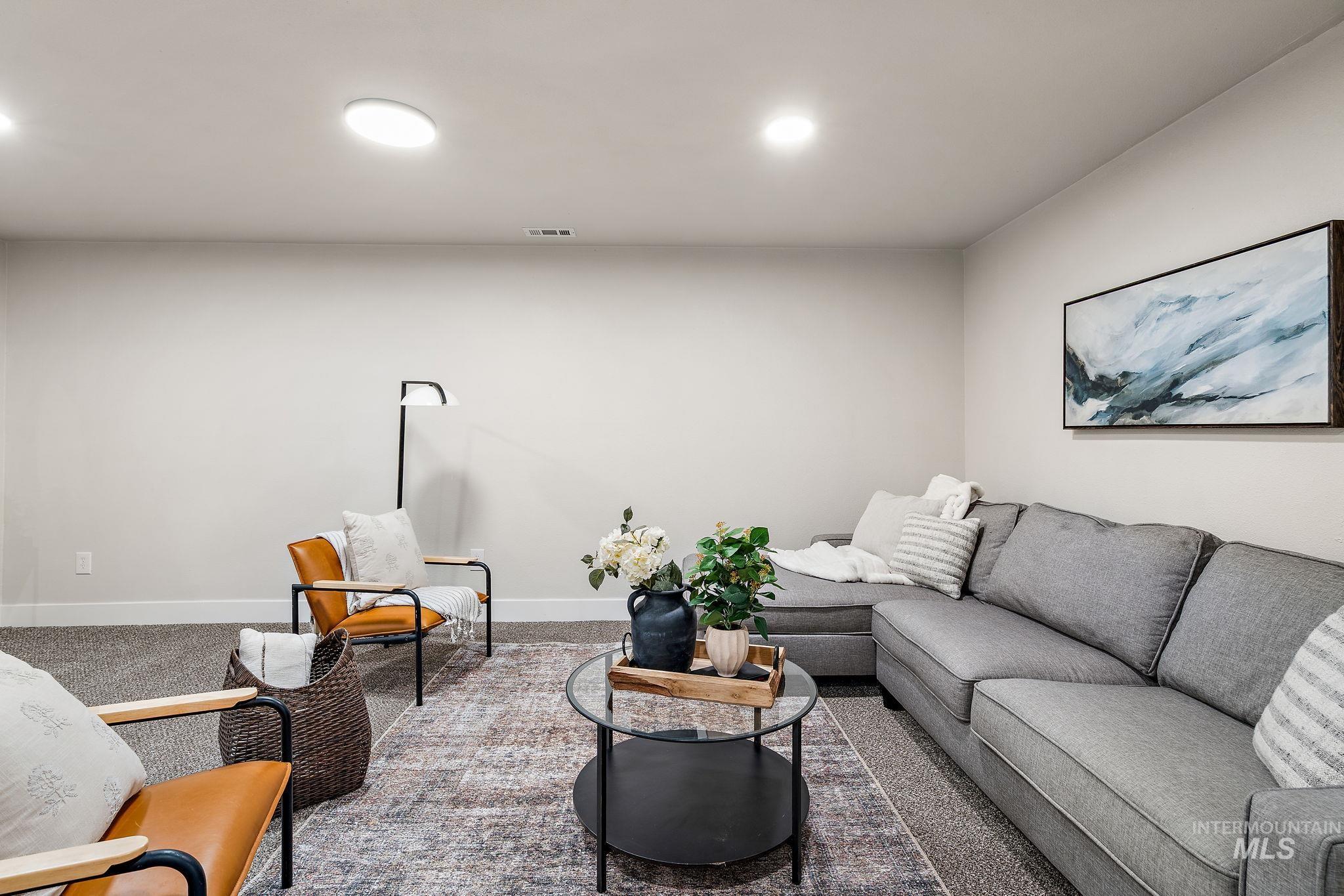 Living area with carpet floors and recessed lighting