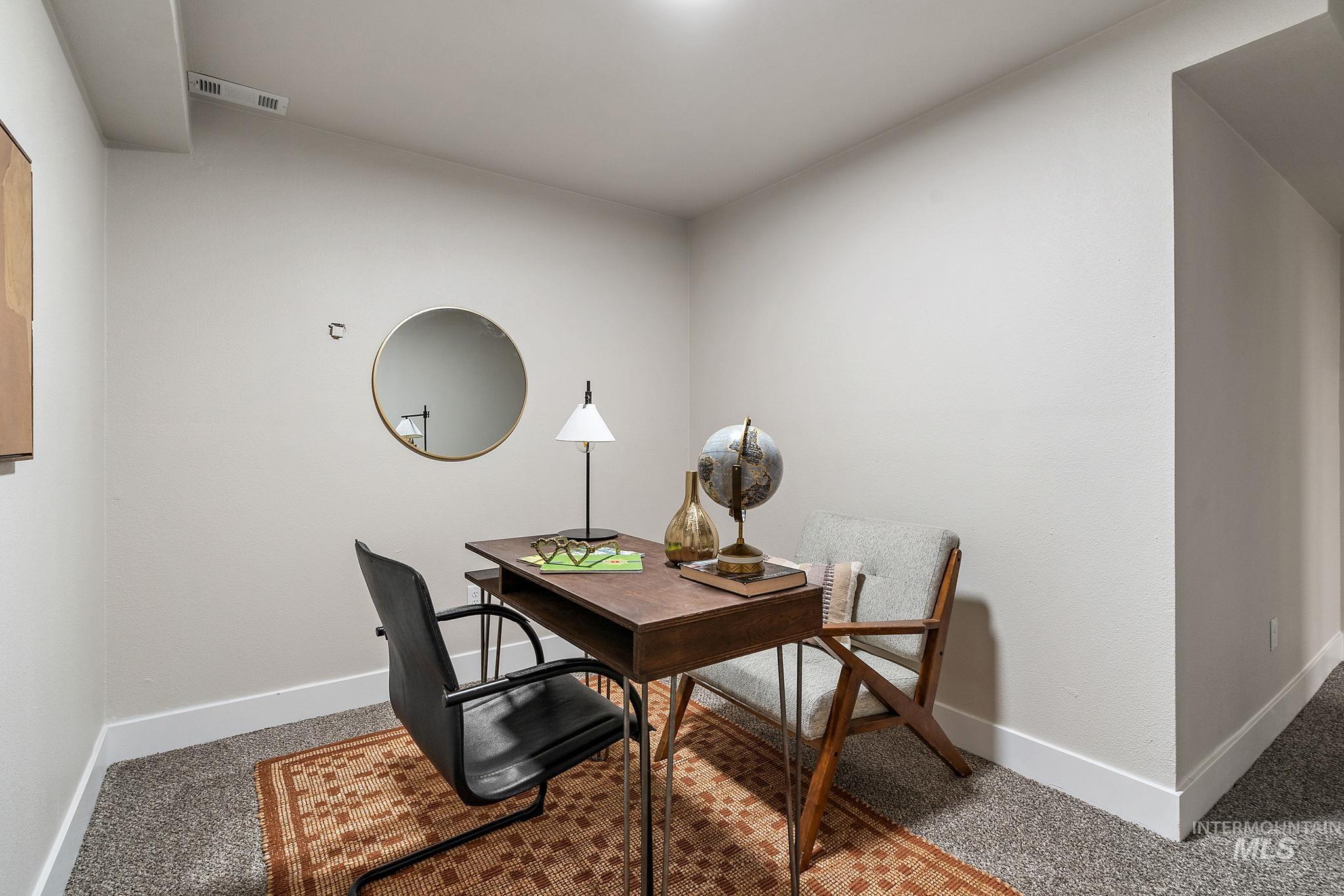 Office with carpet floors and baseboards