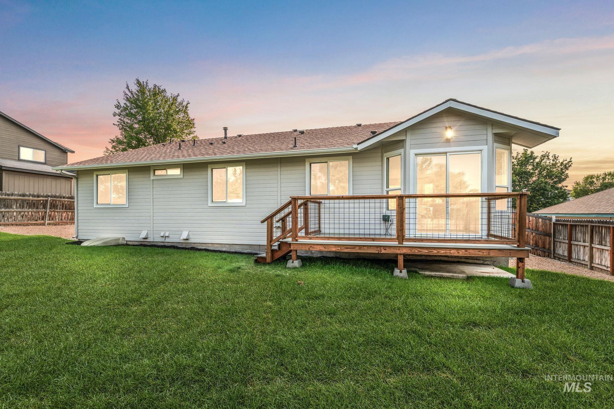 Rear view of property featuring a wooden deck
