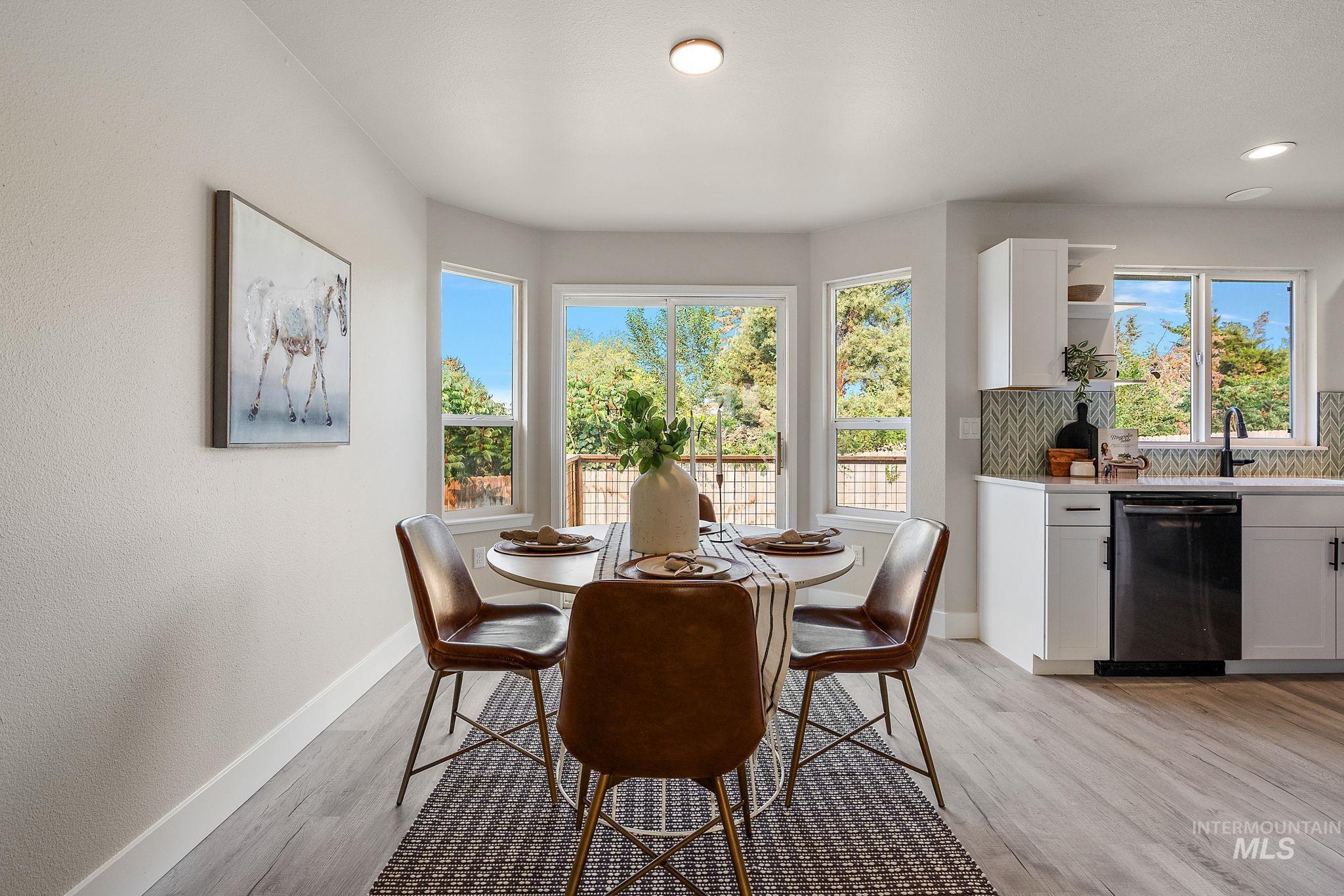 Dining space with baseboards and light wood-style floors