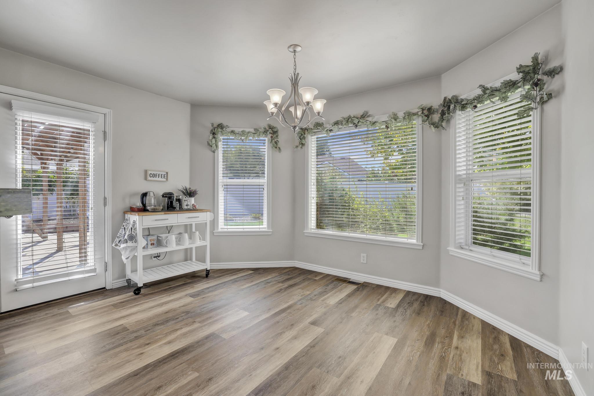 Dining area featuring light wood-style floors and a chandelier