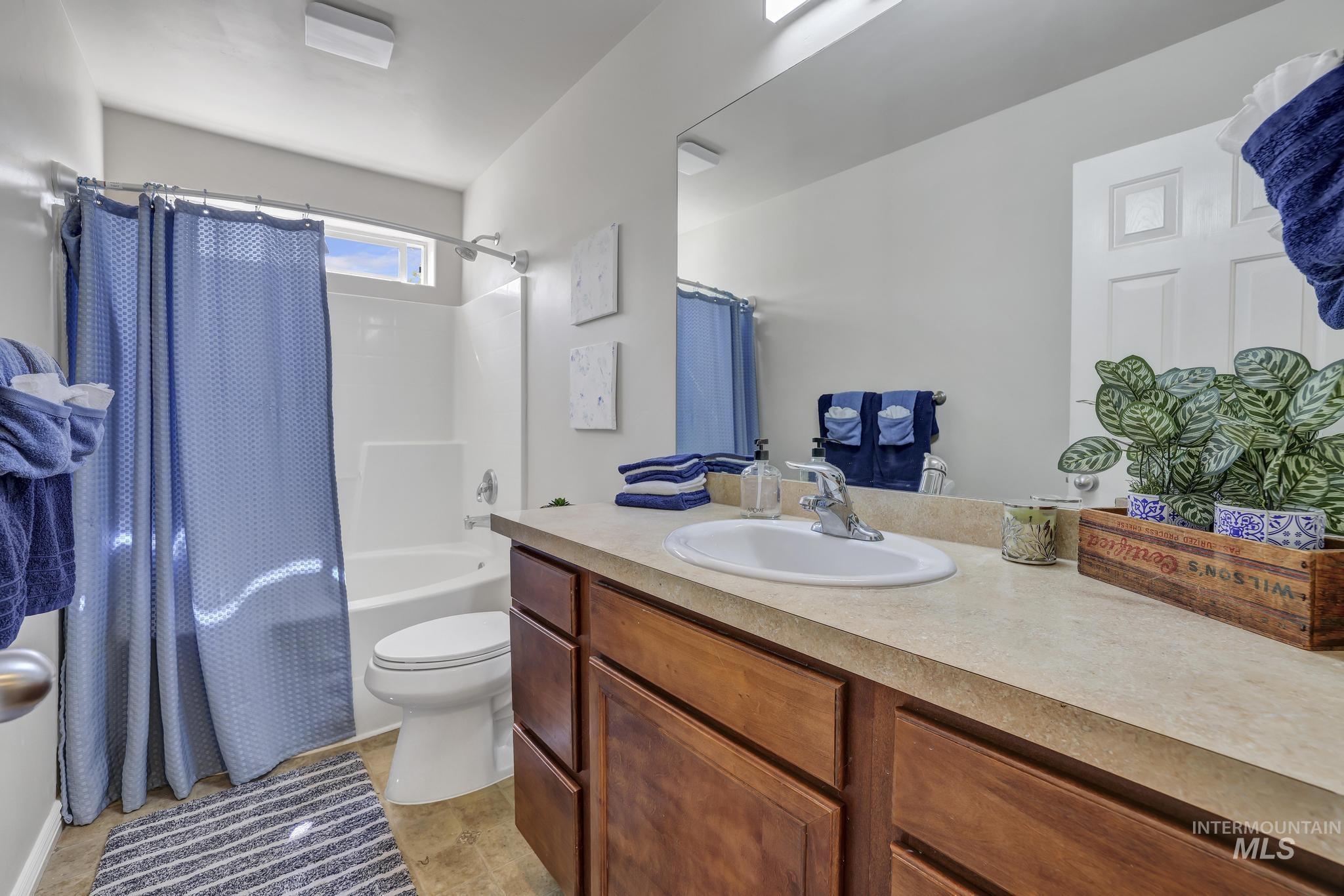 Bathroom featuring shower / bath combo and vanity