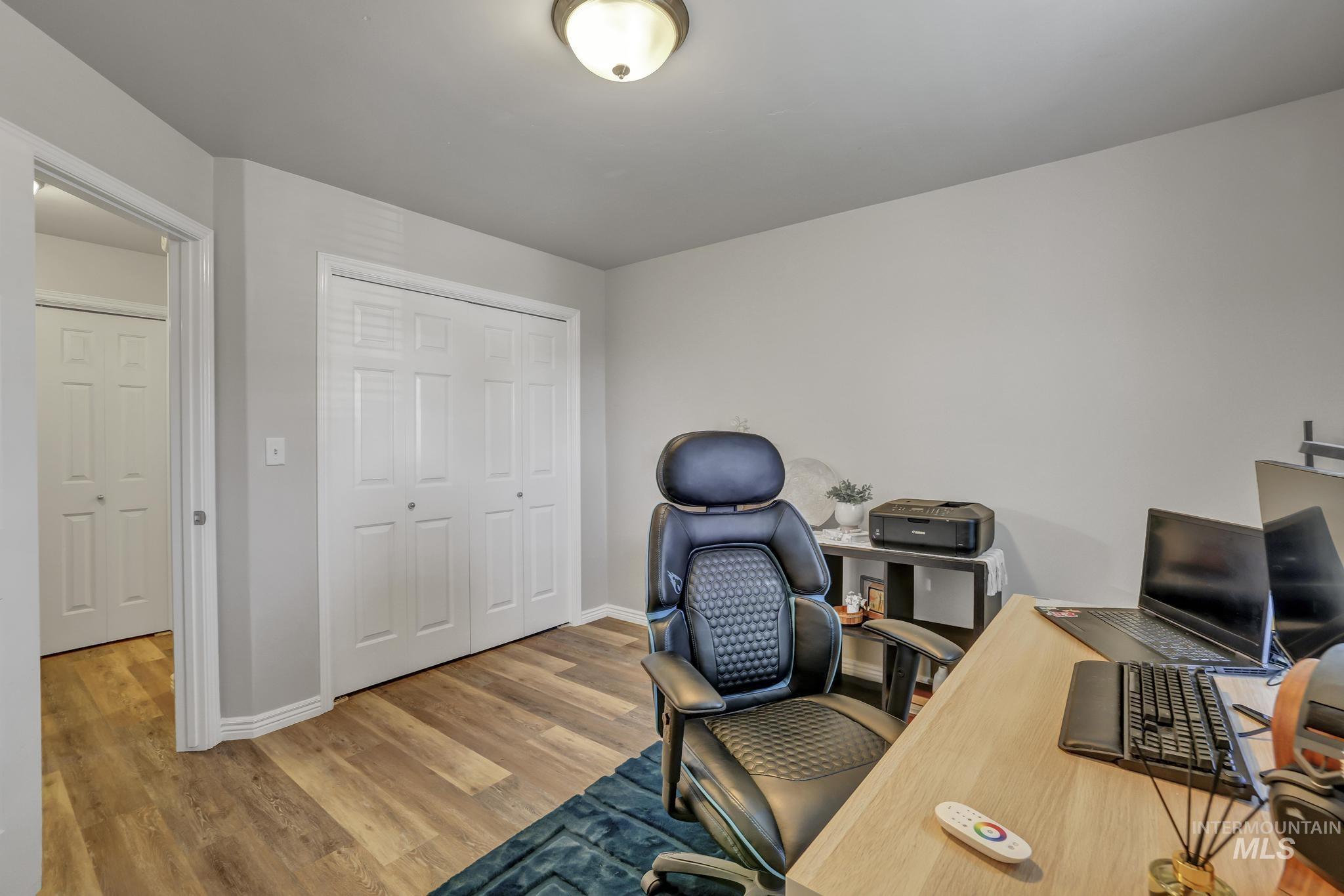 Office space with light wood-style flooring and baseboards