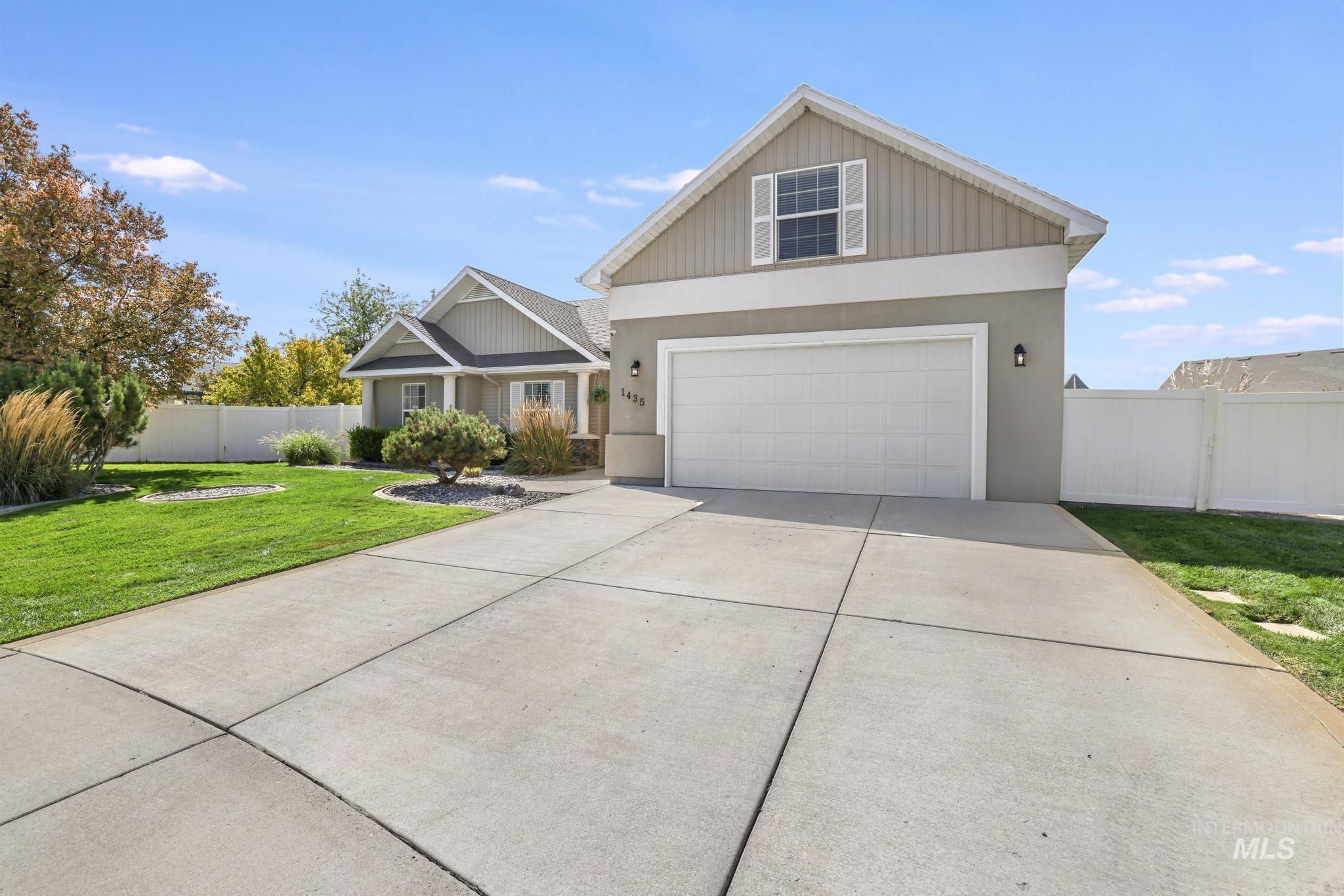 Craftsman-style house featuring driveway and stucco siding