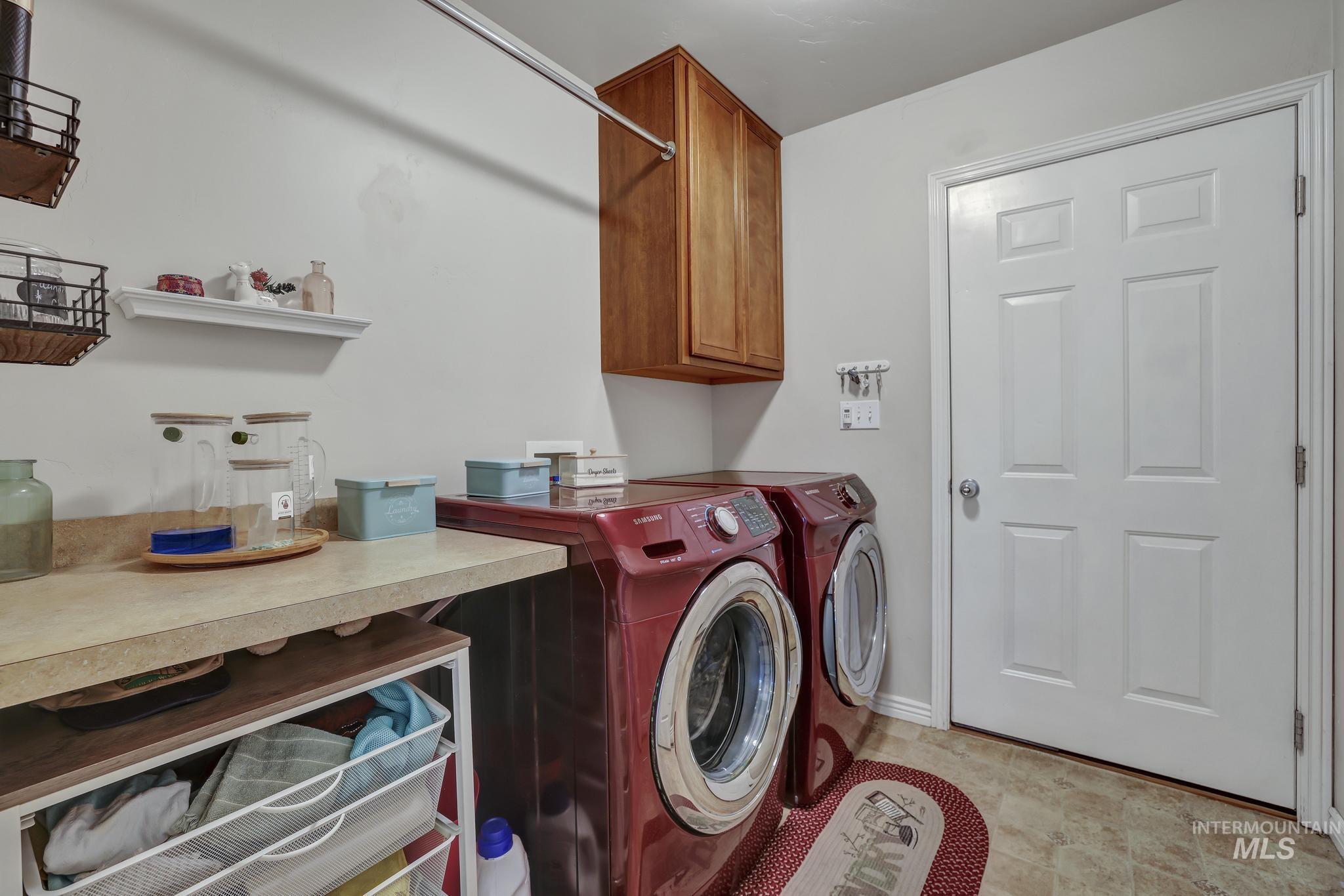Laundry room with cabinet space and independent washer and dryer
