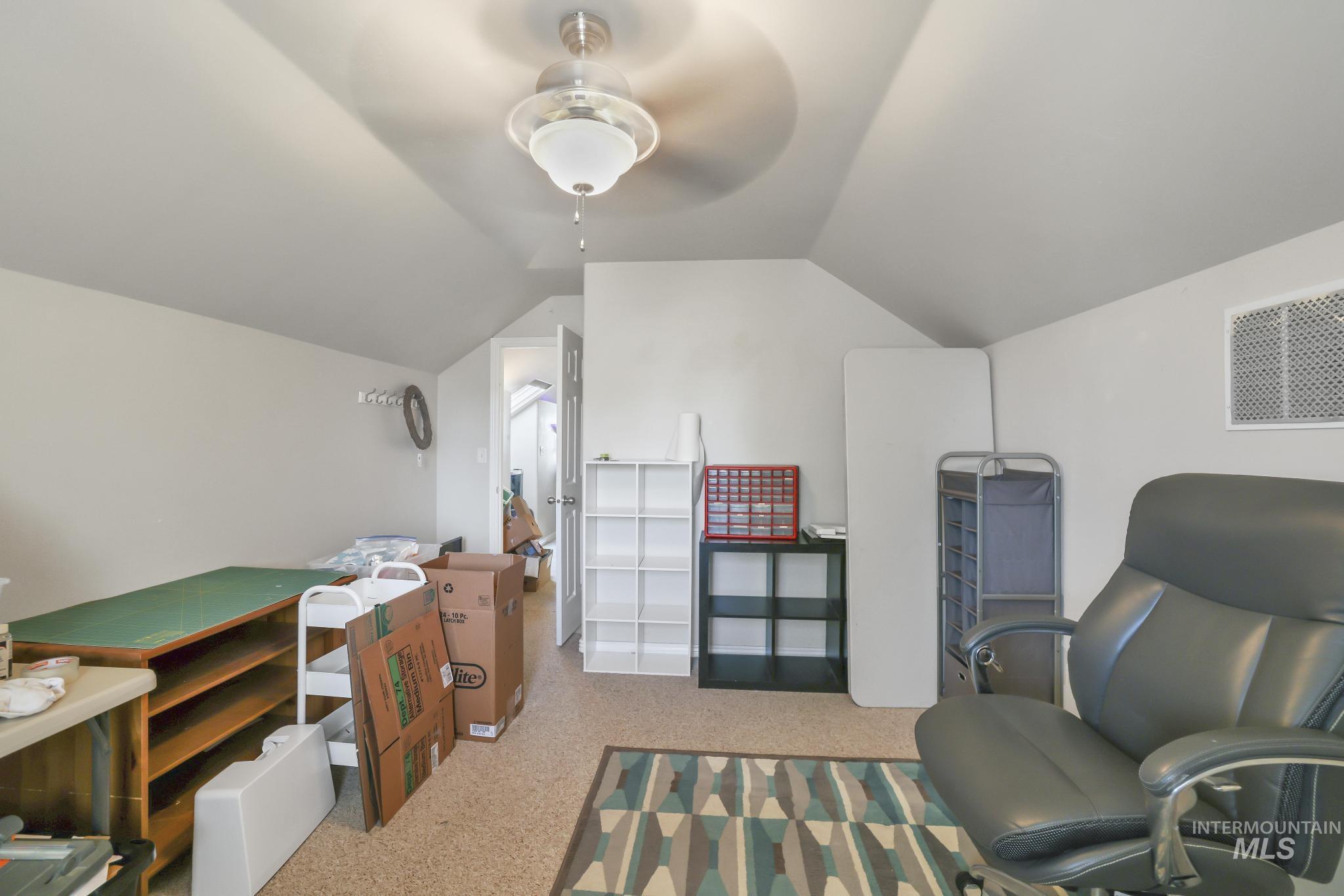Sitting room with lofted ceiling and speckled floor