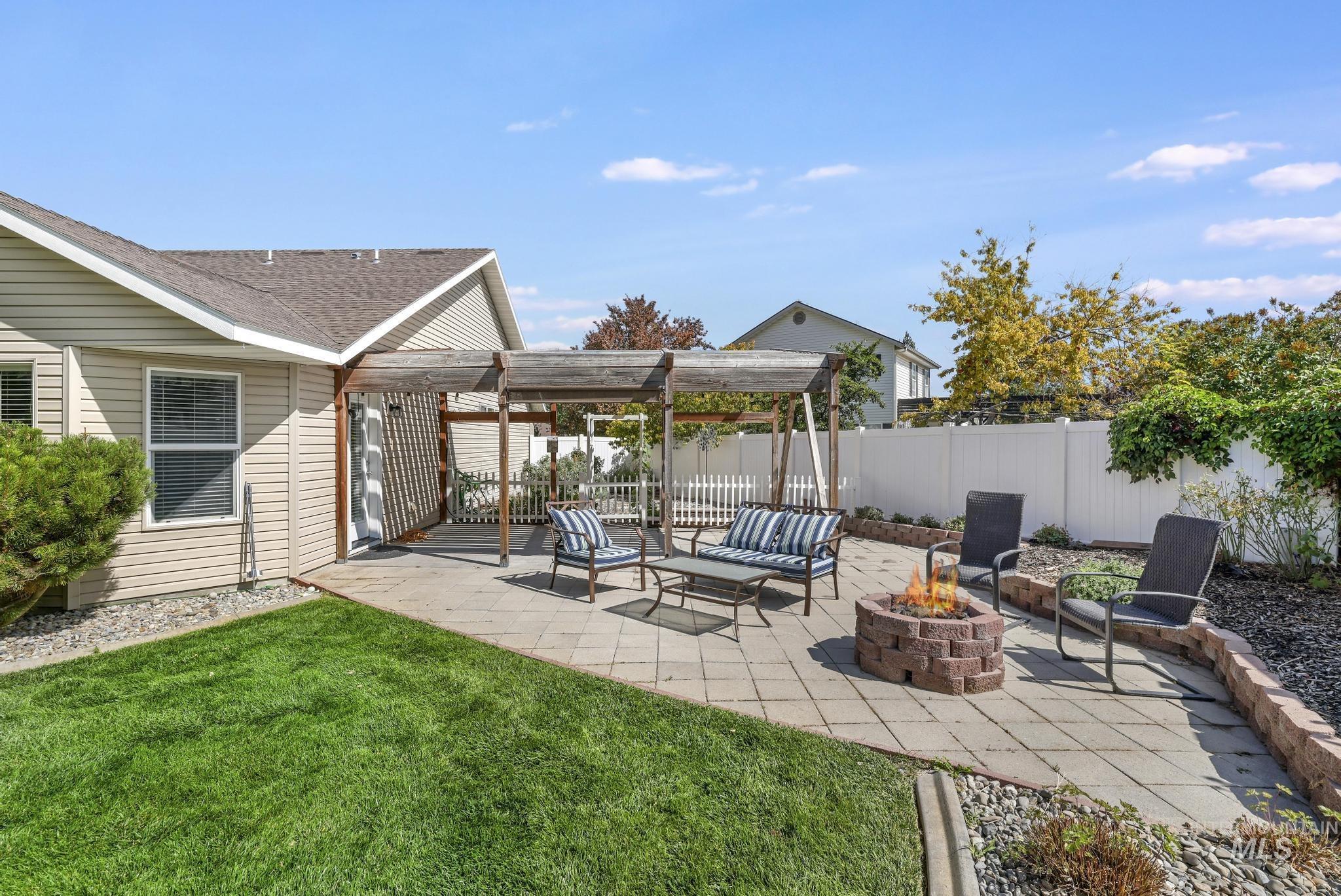View of patio / terrace with an outdoor fire pit and a pergola