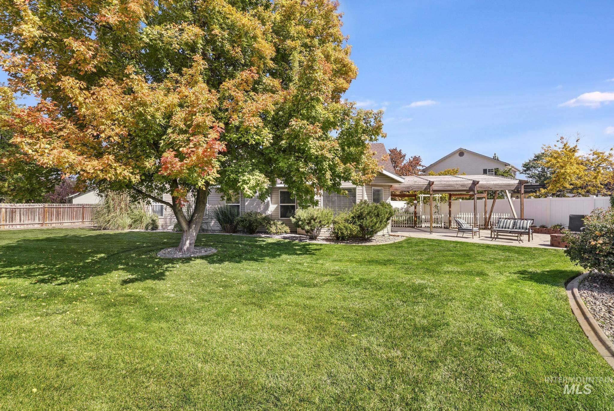 View of yard with a pergola and a patio area