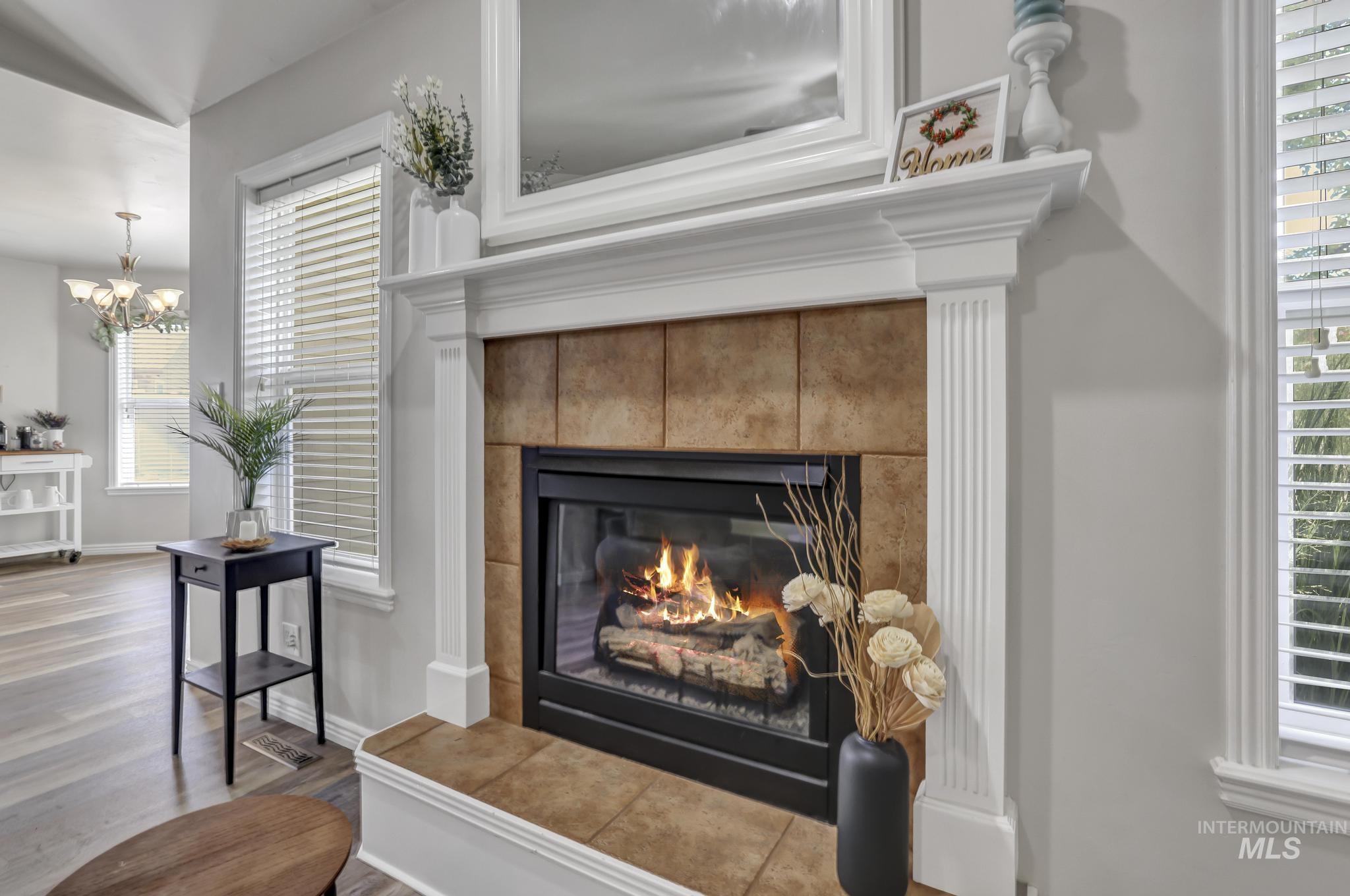 Detailed view of wood finished floors and a tiled fireplace