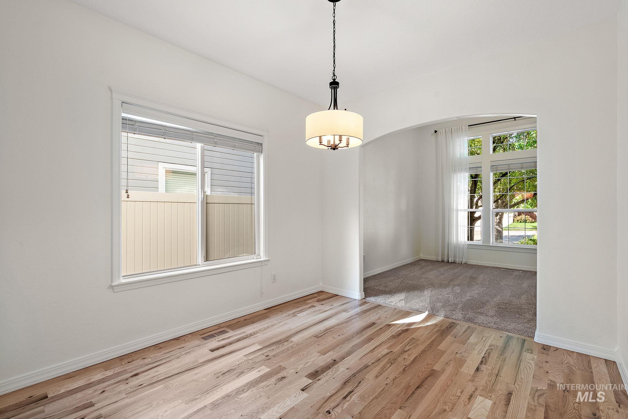 Unfurnished dining area with healthy amount of natural light and light wood-style flooring