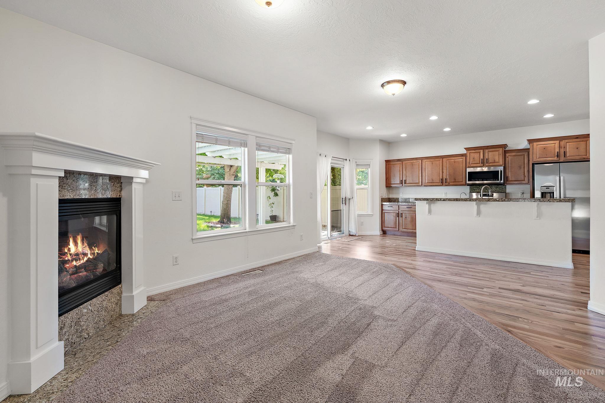 Unfurnished living room with recessed lighting, a fireplace, and light wood-style floors