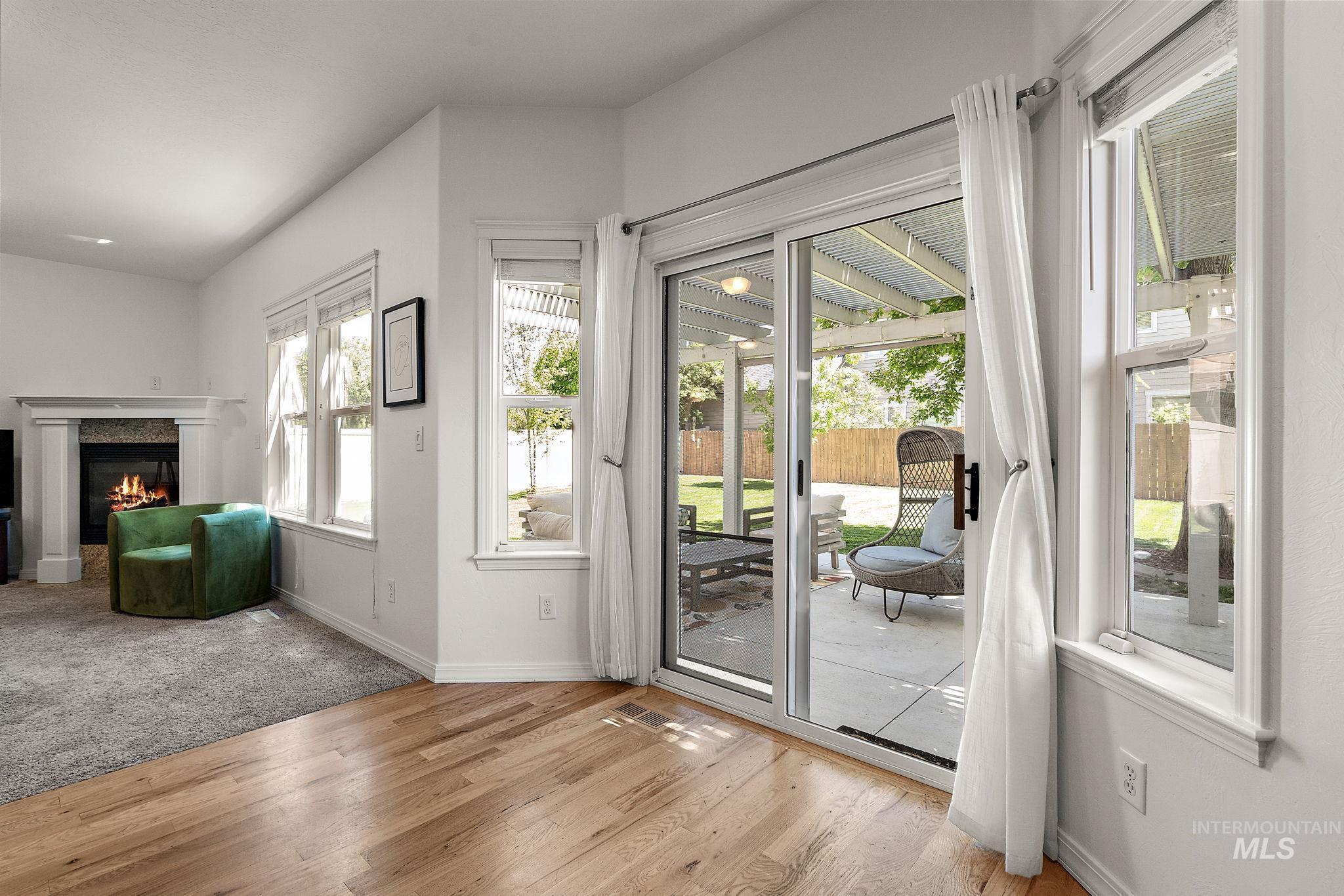 Entryway with wood finished floors and a fireplace