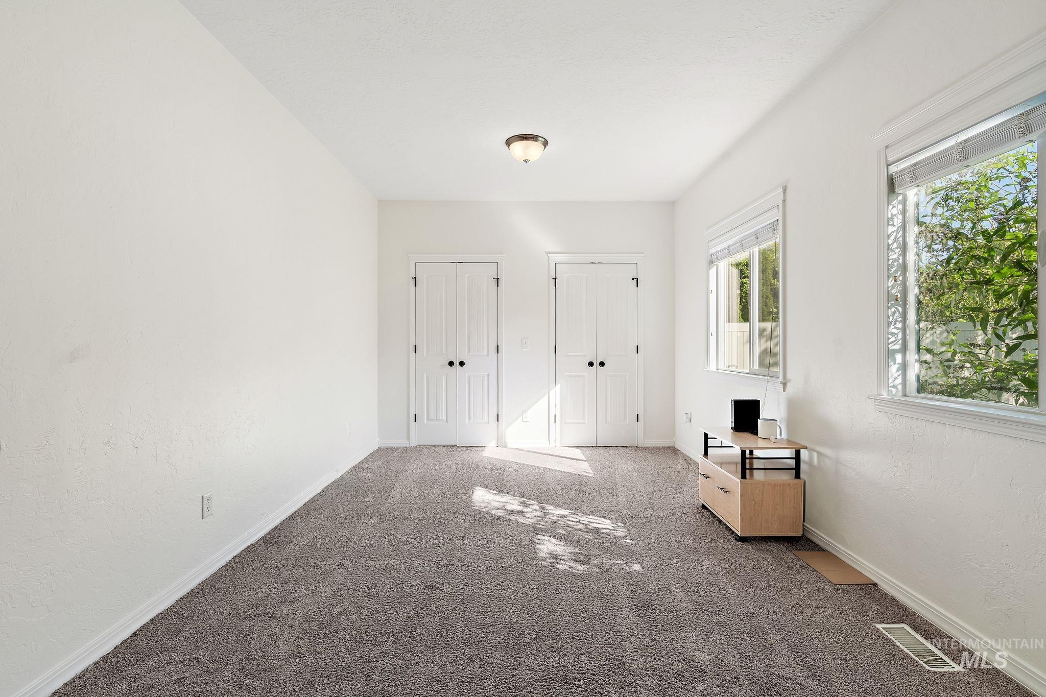 Entryway with carpet and baseboards
