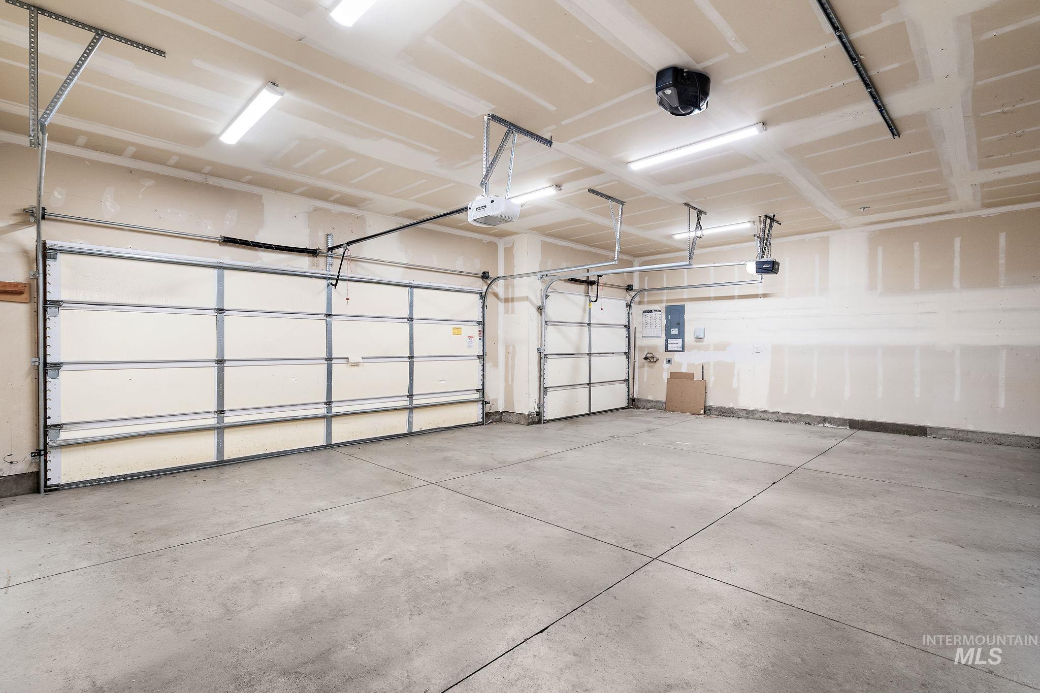 Garage with electric panel and a garage door opener