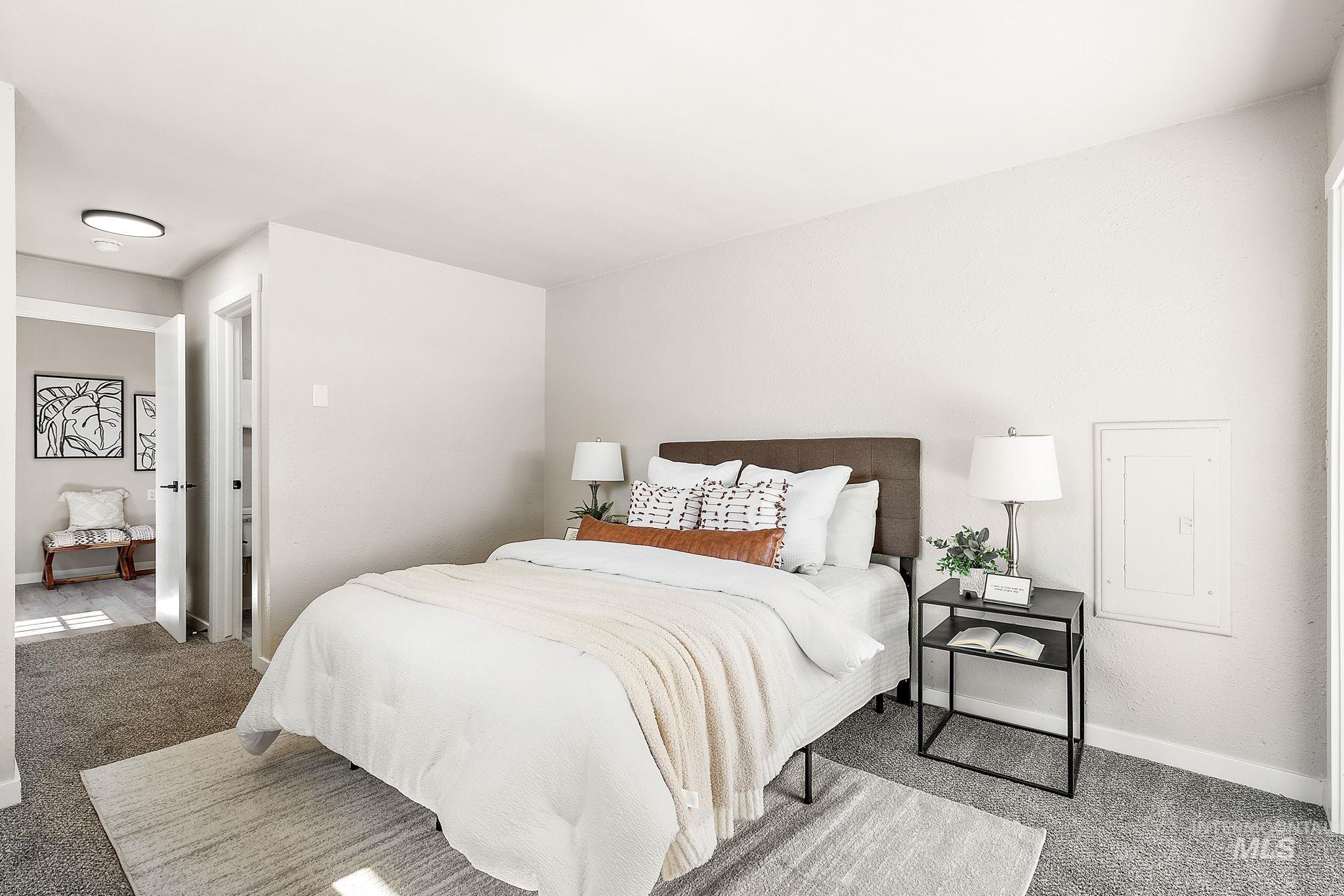 Carpeted bedroom featuring baseboards