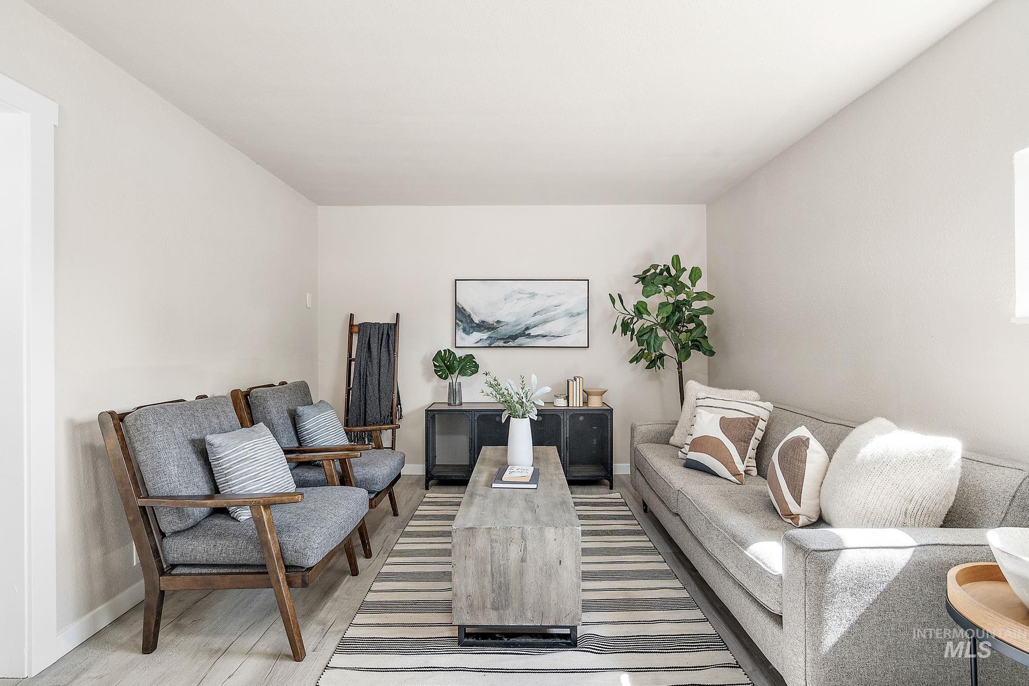 Living area with light wood-style floors and baseboards