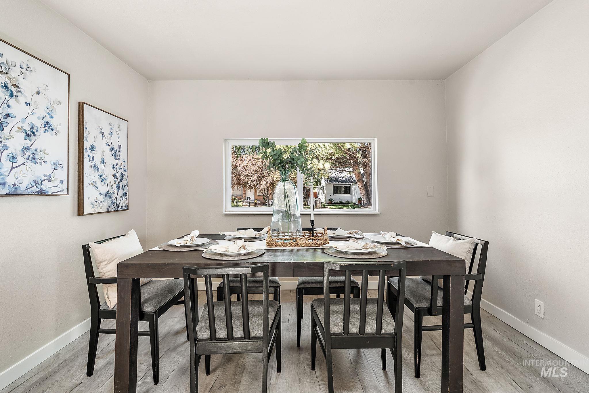 Dining room with baseboards and light wood-type flooring
