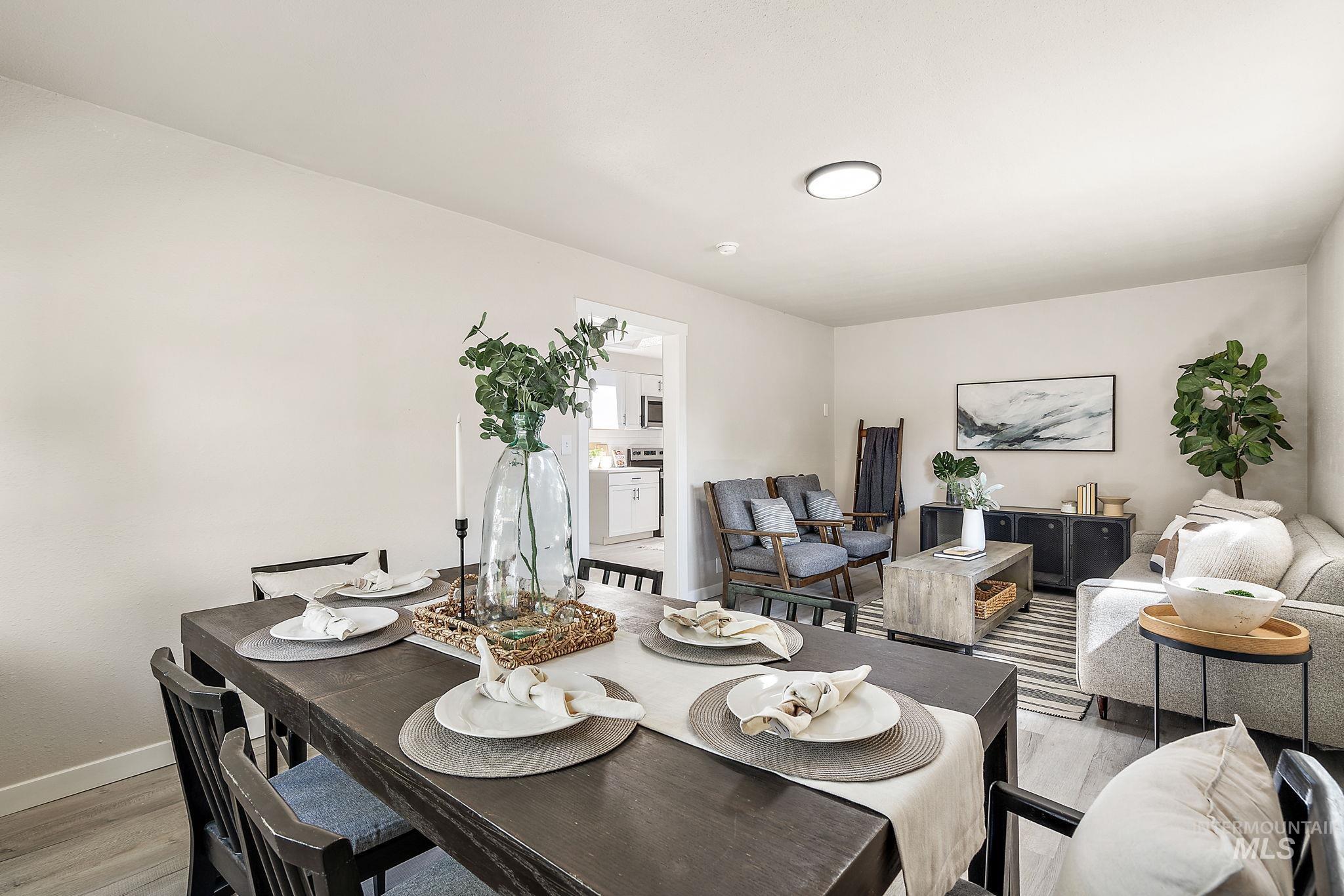 Dining area with light wood-style floors and baseboards
