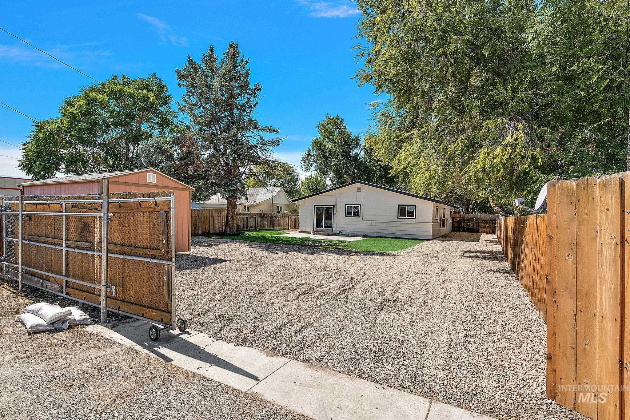 Fenced backyard with a patio area and an outdoor structure