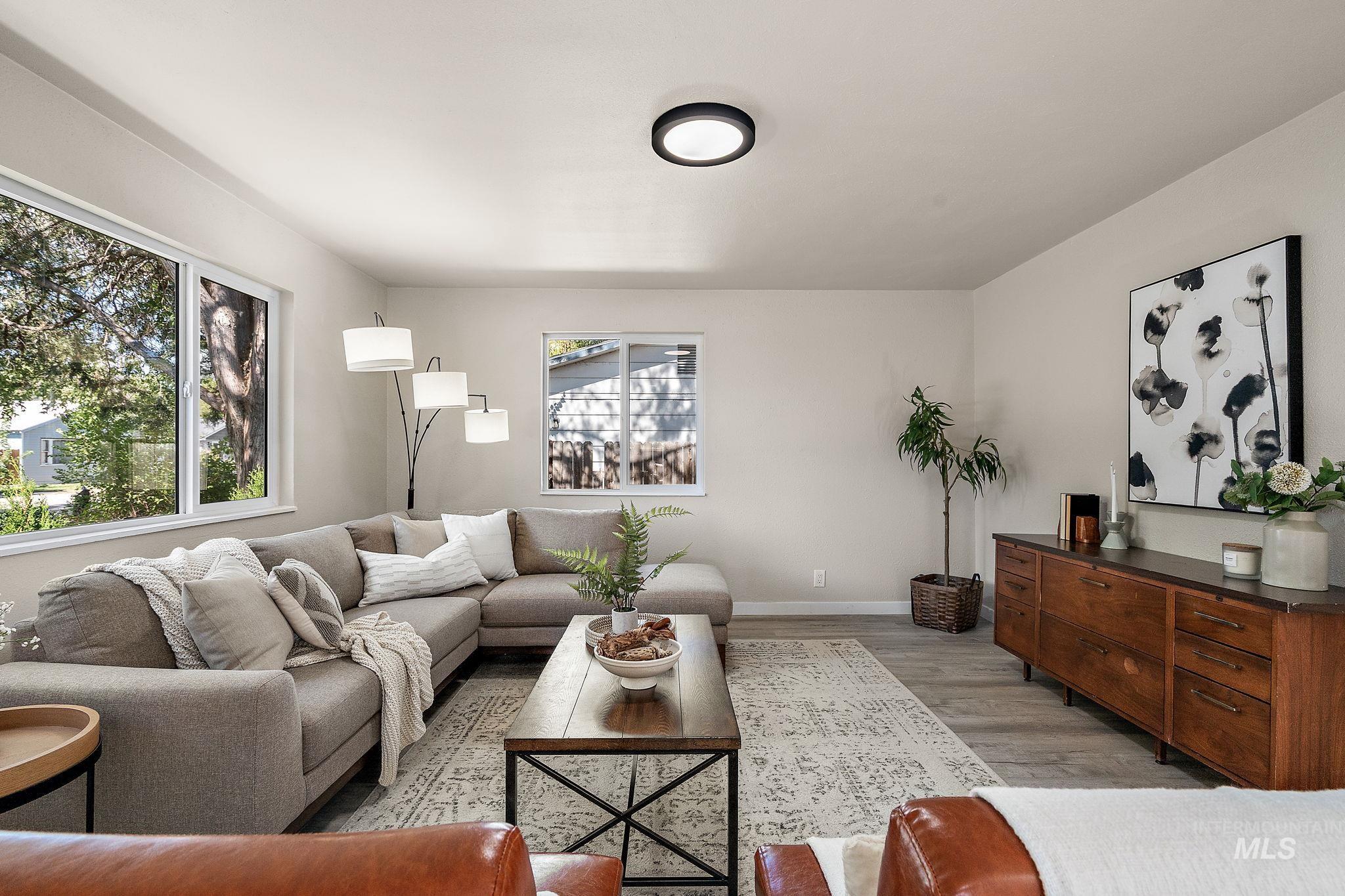 Living area with light wood-style floors and baseboards