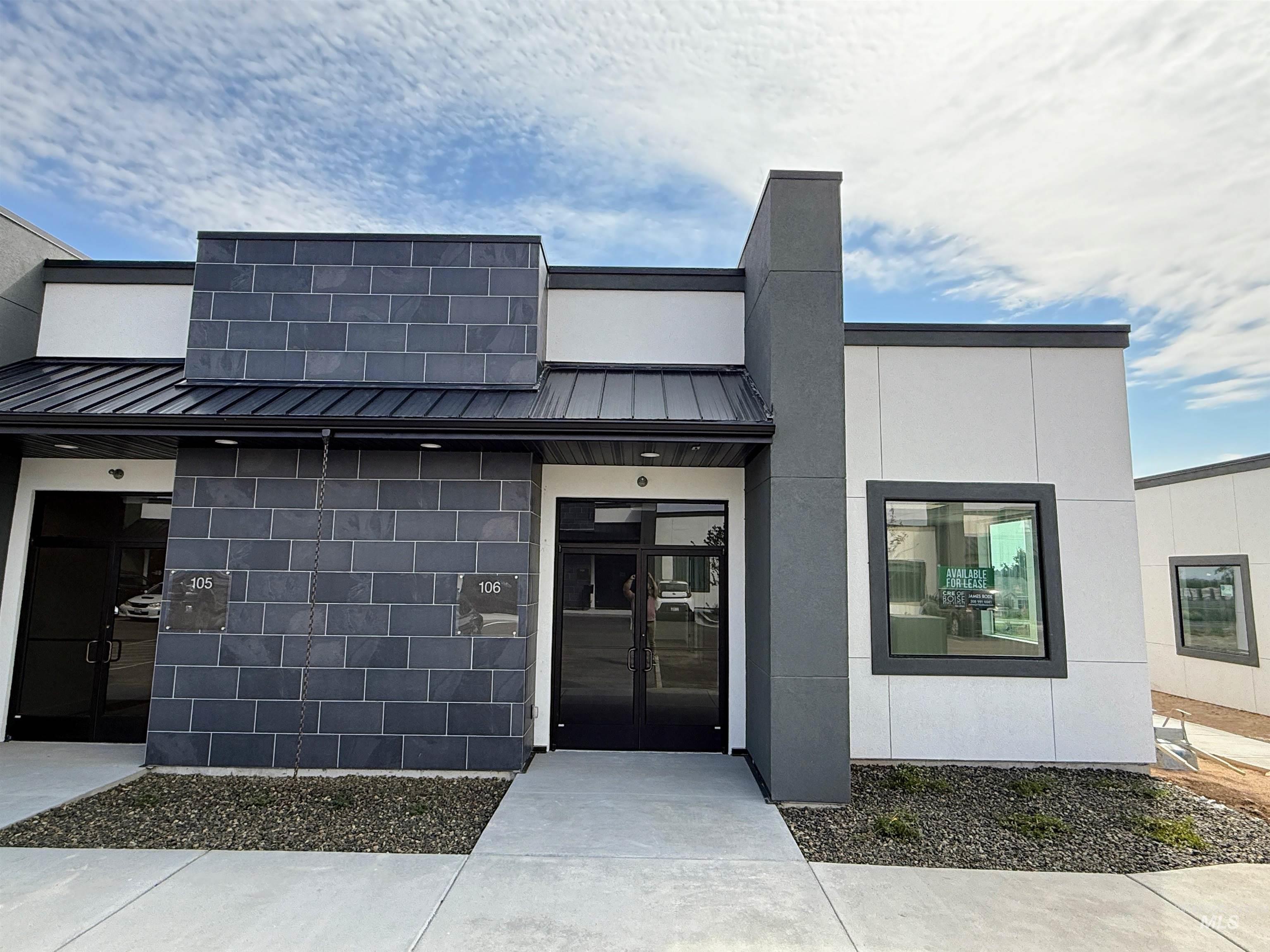 View of front of property featuring a metal roof, a standing seam roof, and stucco siding