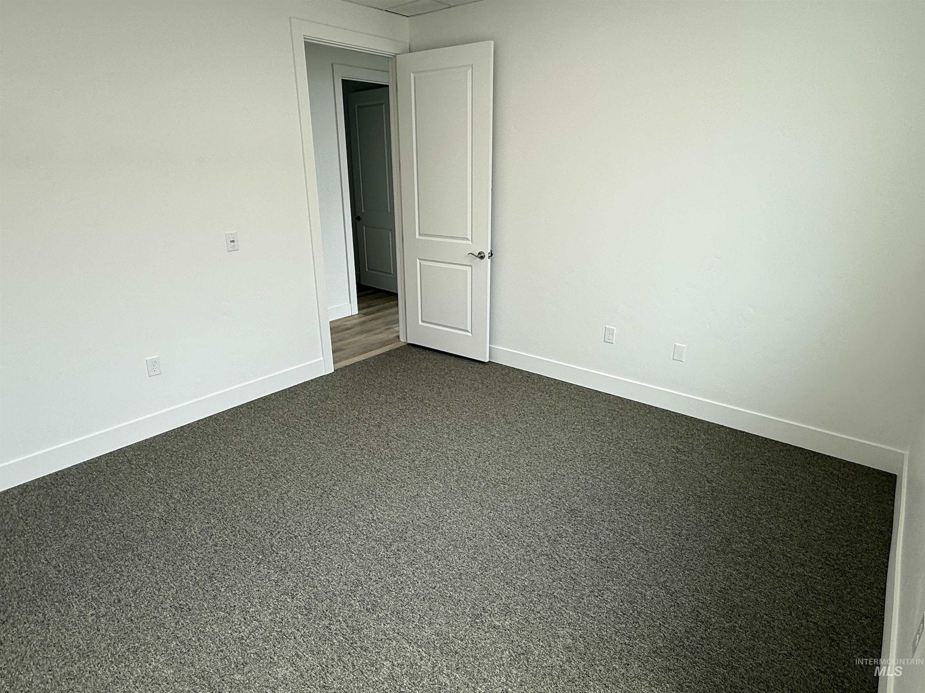 Spare room featuring baseboards