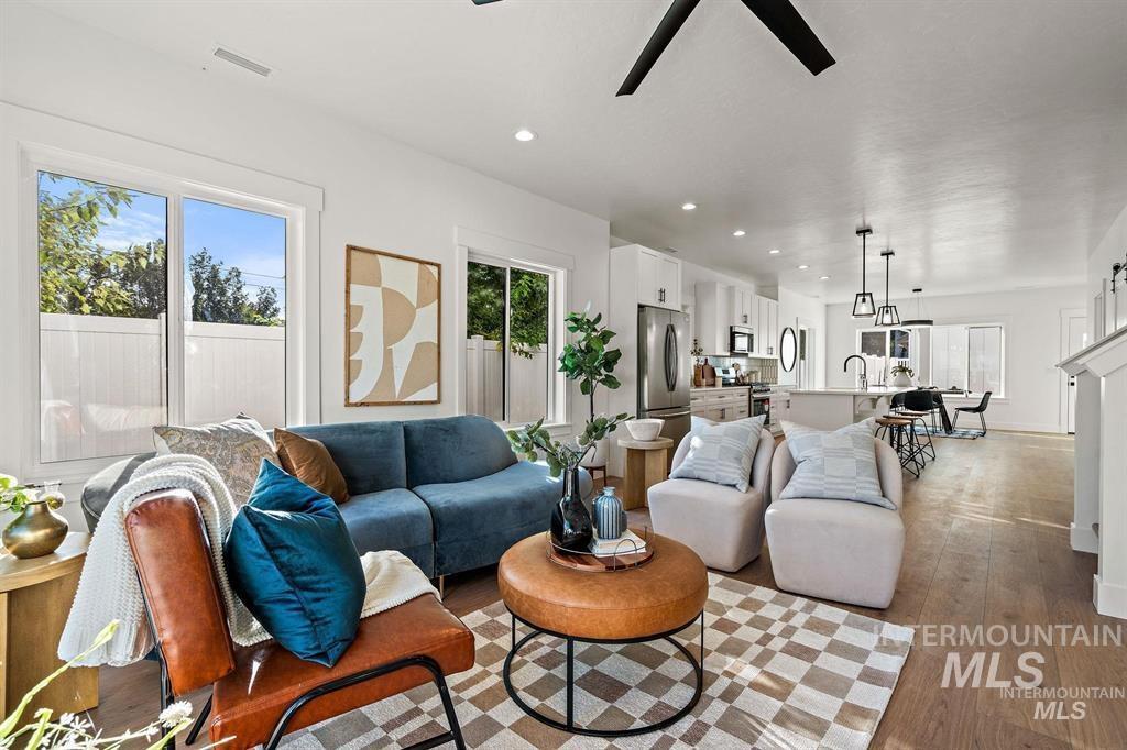 Living area with light wood-style floors, recessed lighting, and a ceiling fan