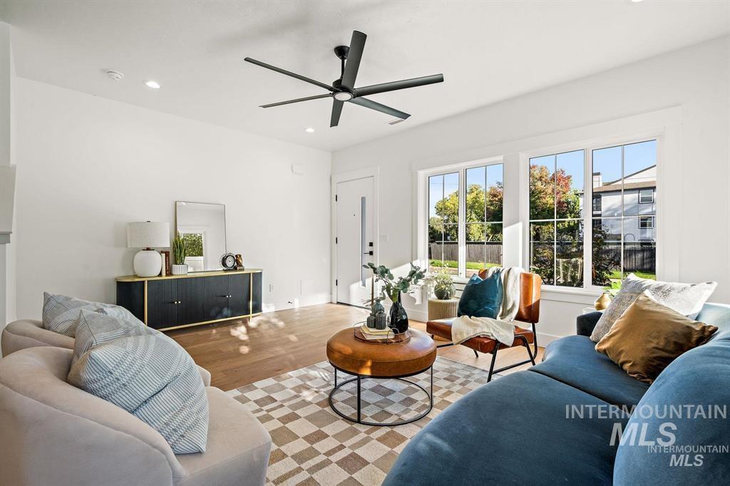 Living area featuring wood finished floors, recessed lighting, and ceiling fan